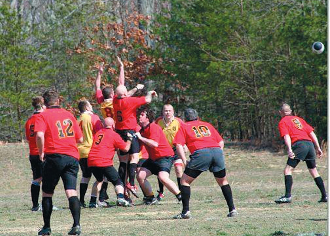 Members of the Pax River Rugby team (in red) face off against the opposing team, the Philadelphia Gryphons, in what is called a lineout during a match last spring.  A member from each team is lifted into the air by their teammmates in effort to gain control of the ball, which is thrown in from the sideline. (Courtesy photo)