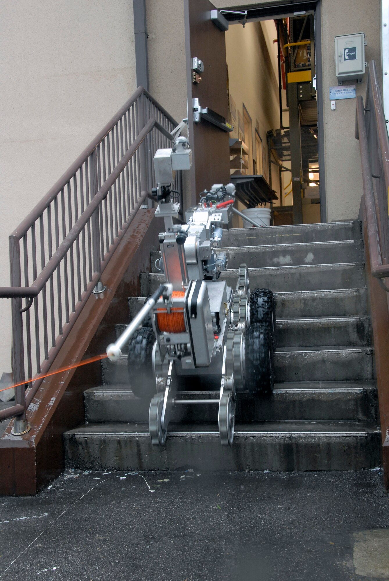 An F6A robot, used by explosive ordnance disposal Airmen with the 51st Civil Engineer Squadron at Osan Air Base, South Korea, prepares to remove a suspicious package at the base post office during a base-wide exercise July 24. The robot is equipped with several television cameras for remote viewing and a dexterous arm for hazardous tasks. (U.S. Air Force photo/Staff Sgt. Lakisha Croley)