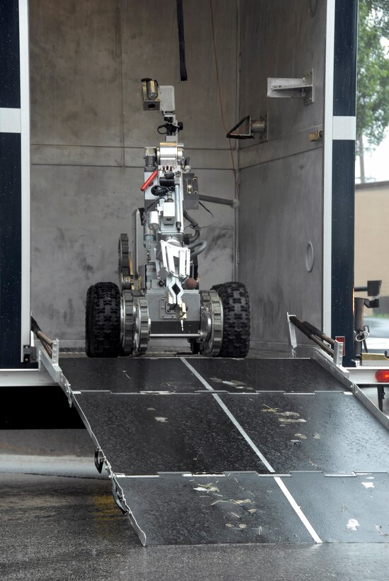 Explosive ordnance disposal Airmen use an F6A robot to handle suspicious packages.  During a base-wide exercise July 24 at Osan Air Base, South Korea, EOD specialists with the 51st Civil Engineer Squadron responded to a "suspicious package" alert at the base post office and brought out the F6A. The robot is equipped with several television cameras for remote viewing and a dexterous arm for hazardous tasks. (U.S. Air Force photo/Staff Sgt. Lakisha Croley)