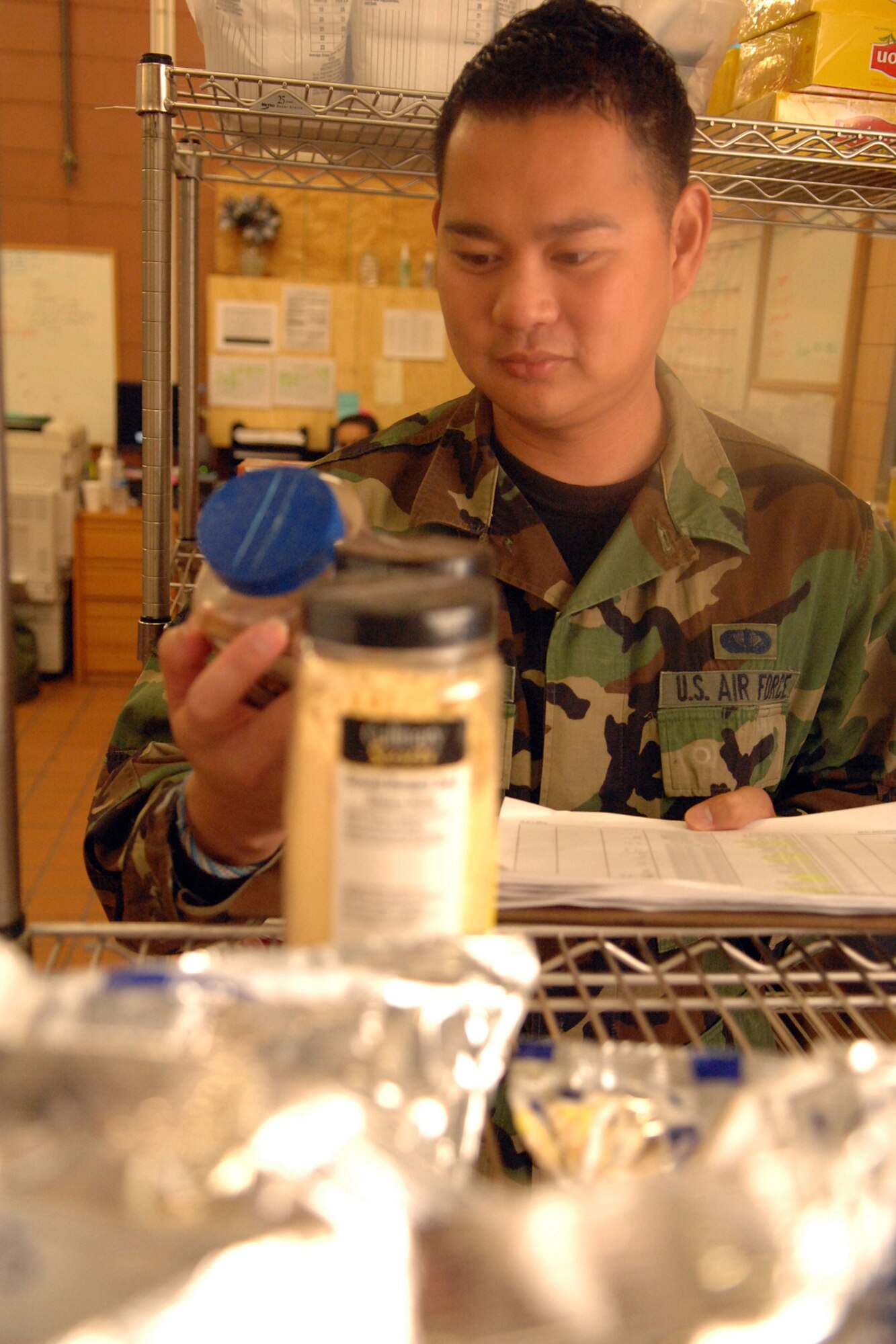 Staff Sgt. Joe Angeles,  49th Force Support Squadron, takes inventory of items in the store room at the Shifting Sands Dining Facility at Holloman Air Force Base, N.M.,  July 11. The Airmen who work in the store room are responsible for keeping track of the amount of food they have and ordering more food when needed. (U.S. Air Force photo/Airman Sondra M. Wieseler)