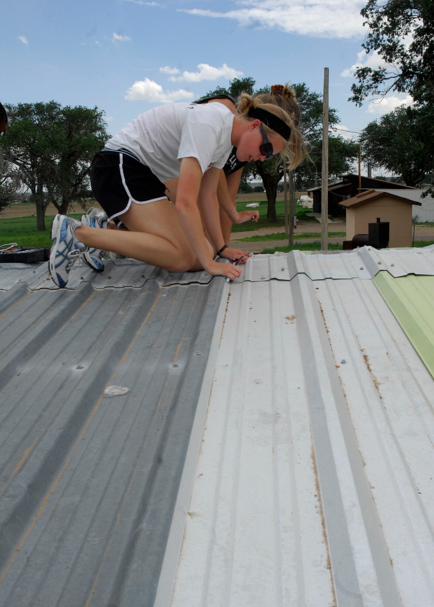 CANNON AIR FORCE BASE, N.M. -- U.S. Air Force Reserve Officer Training Corps cadet Kaithlyn Radius, helps repair a roof at the New Mexico Baptist Children's Home in Portales, N.M., July 19 as part of Operation Air Force. The cadets from detachments at universities across the nation participated in this three-week program designed to expose future leaders to the Air Force.  (U.S. Air Force photo/ Airman 1st Class Evelyn Chavez)