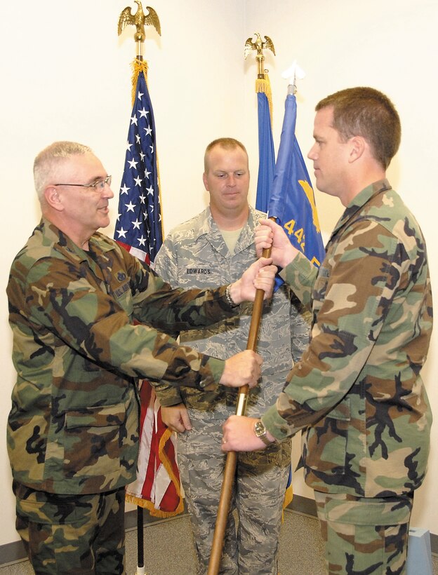 The 442nd Mission Support Group commander, Col. John Larson, passes the 442nd Civil Engineer Squadron guidon to the squadron's new commander, Maj. Mark Davison, July 12, 2008.  (U.S. Air Force Photo/Staff Sgt. Tom Talbert)