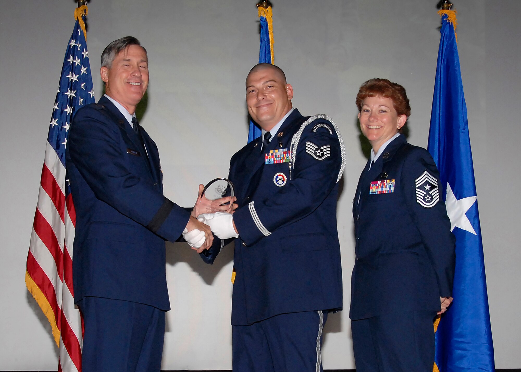 Brig. Gen. O.G. Mannon, 82nd Training Wing commander, presents Staff Sgt. Terry Hillger, 882nd Training Group, with the NCO Honor Guardsmen of the Quarter award, July 30. (U.S. Air Force photo/Mike Litteken) 
 
