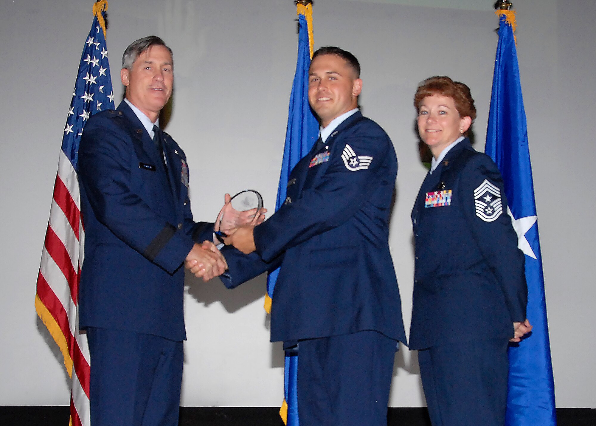 Brig. Gen. O.G. Mannon, 82nd Training Wing commander, presents Staff Sgt. Eric Sinclair, 782nd Training Group, with the Noncommissioned Officer of the Quarter award, July 30. (U.S. Air Force photo/Mike Litteken) 
 
