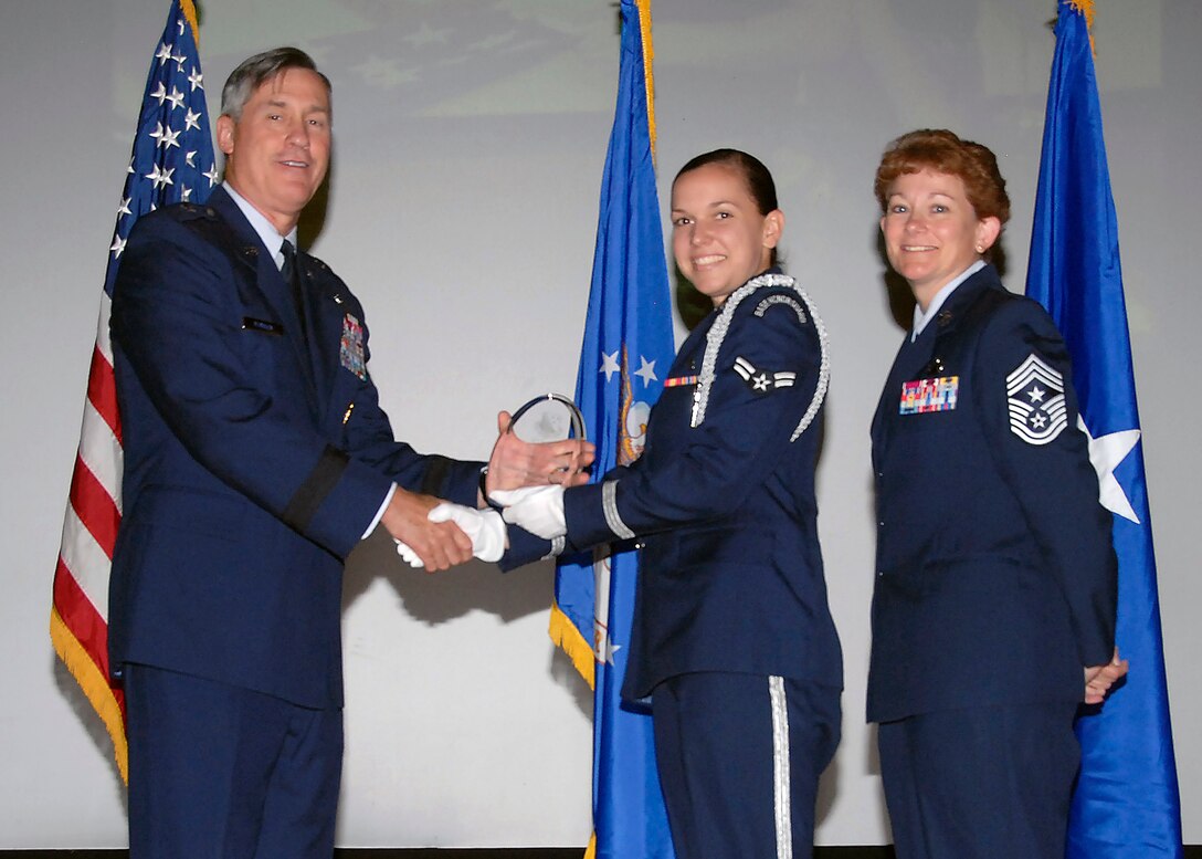 Brig. Gen. O.G. Mannon, 82nd Training Wing commander, presents Airman 1st Class Casey Caraballo, 82nd Medical Group, with the Airman Honor Guardsmen of the Quarter award, July 30. (U.S. Air Force photo/Mike Litteken) 
 
