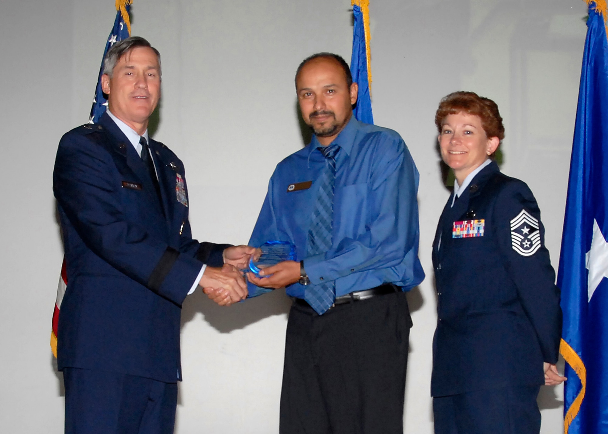 Brig. Gen. O.G. Mannon, 82nd Training Wing commander, presents Edwardo Morales, 82nd Training Group, with the Civilian Volunteer of the Quarter award, July 30. (U.S. Air Force photo/Mike Litteken) 
 
