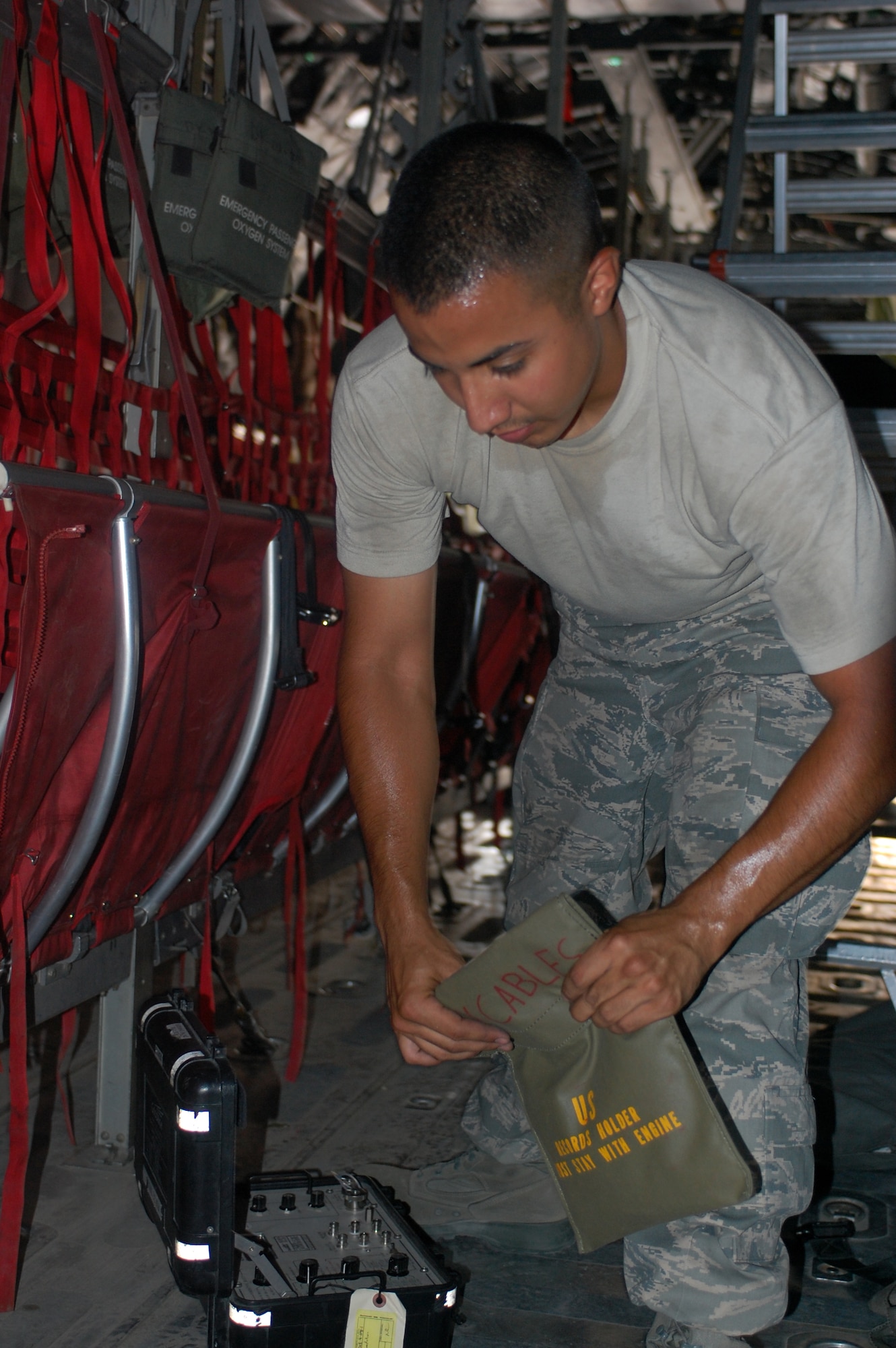 SOUTHWEST ASIA -- Senior Airman James Rivas, assigned to the 386th Expeditionary Aircraft Maintenance Squadron, packs up a fuel quantity test set on a C-130 aircraft during a home station check on July 26 at a base in Southwest Asia. The inspection, performed every eight months, combines the efforts of crew chiefs, communications navigations and guidance and control system specialists and a host of others in order to ensure the continued performance of the aircraft throughout the U.S. Central command area of responsibility. Airman Rivas is deployed from Dyess Air Force Base, Texas. (U.S. Air Force photo/Staff Sgt. Vincent Borden)