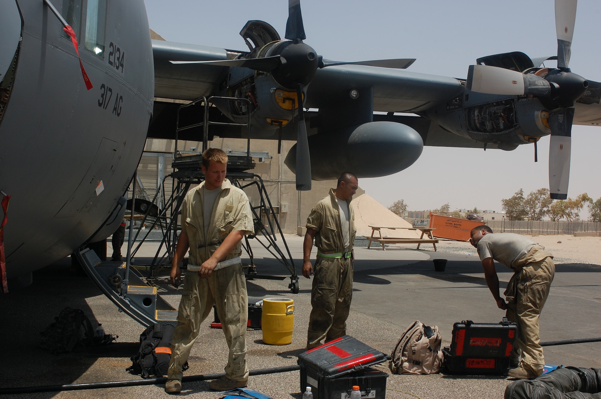 SOUTHWEST ASIA -- Maintenance personnel prepare to perform numerous general and special inspections on different parts of a C-130 aircraft during a home station check on July 26 at a base in Southwest Asia. The inspection, performed every eight months, combines the efforts of crew chiefs, communications navigations and guidance and control system specialists and a host of others in order to ensure the continued performance of the aircraft throughout the U.S. Central command area of responsibility. (U.S. Air Force photo/Staff Sgt. Vincent Borden)