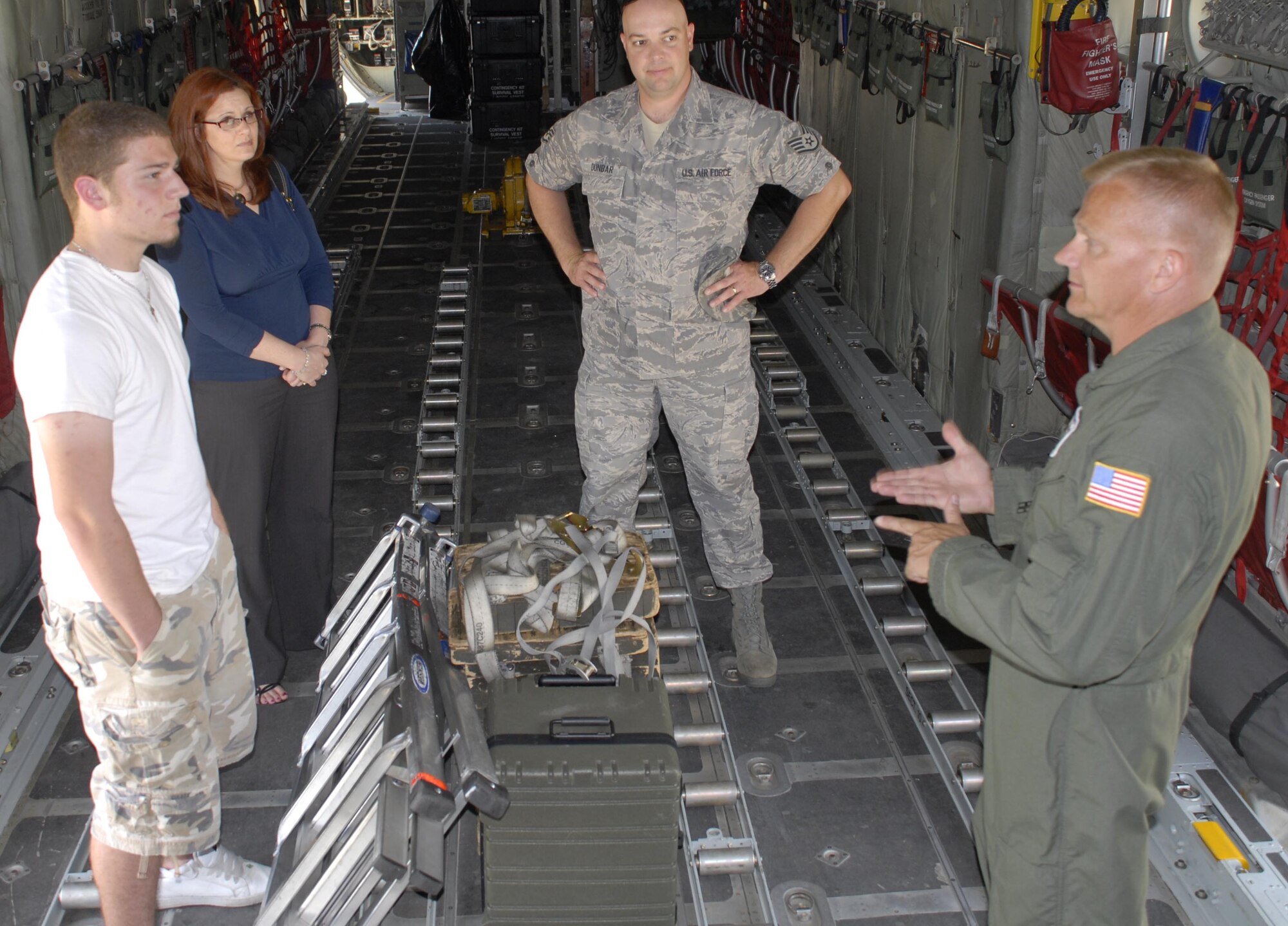 Senior Master Sgt. Robert Arkulary,(far right) 96th Airlift Squadron loadmaster, talks about the loadmaster career field with potential recruit, Jeremy Arsenault, and his mother, Ashley Arsenault, during a C-130 tour arranged by recruiter Staff Sgt. Craig Dunbar (center). (Air Force Photo/Master Sgt. Paul Zadach)