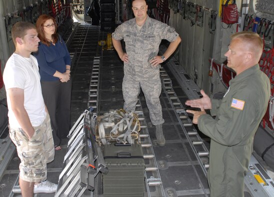 Senior Master Sgt. Robert Arkulary,(far right) 96th Airlift Squadron loadmaster, talks about the loadmaster career field with potential recruit, Jeremy Arsenault, and his mother, Ashley Arsenault, during a C-130 tour arranged by recruiter Staff Sgt. Craig Dunbar (center). (Air Force Photo/Master Sgt. Paul Zadach)