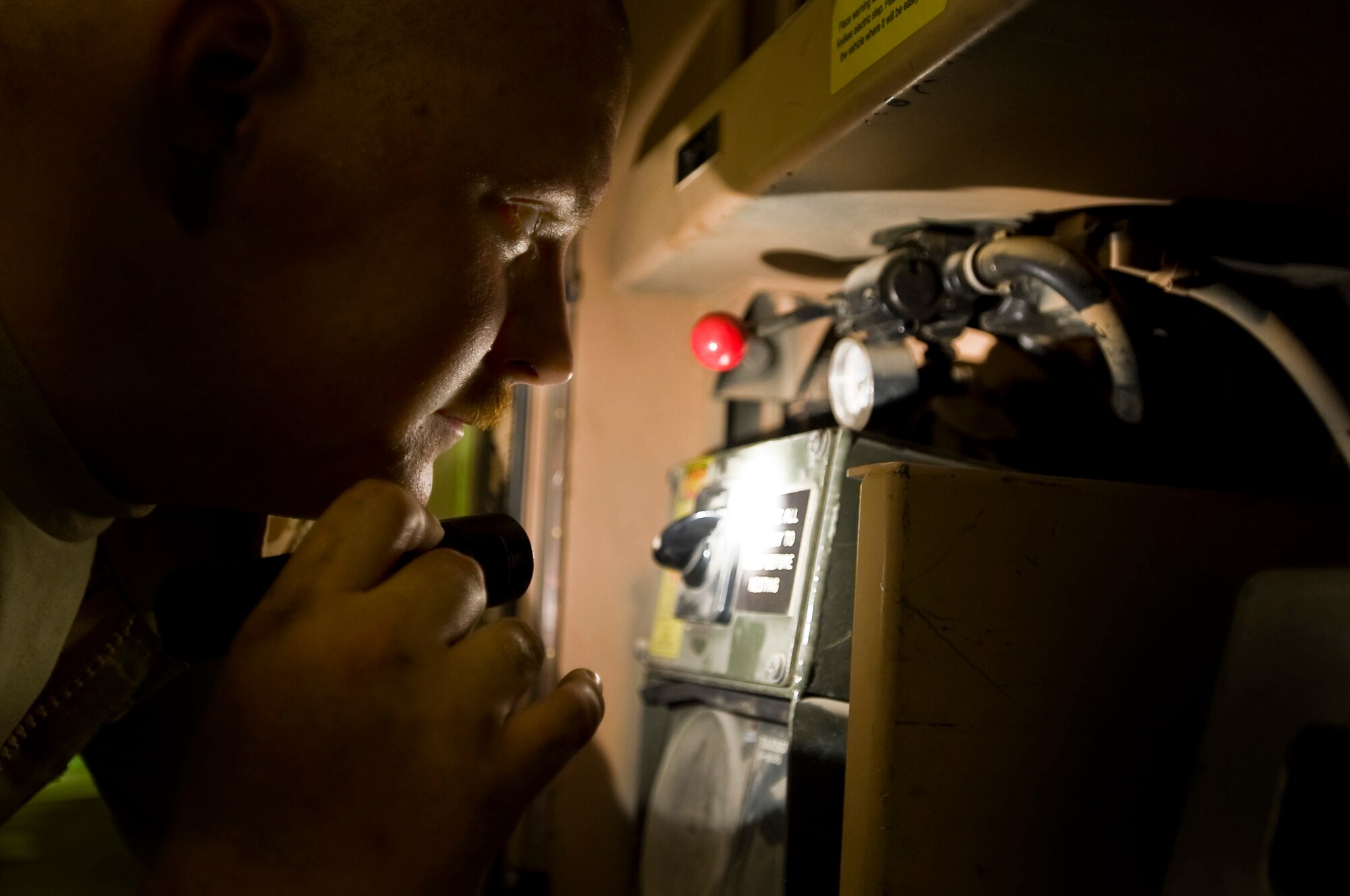 ALI BASE, Iraq -- Senior Airman Matthew Barker, 407th Expeditionary Logistics Readiness Squadron fire truck mechanic, searches for an air leak to a light mast on a 407th Expeditionary Civil Engineer Squadron fire truck July 30, 2008. Airmen in the vehicle maintenance shop here maintain all Air Force vehicle assets, more than 300 vehicles and other heavy machinery. Vehicle oil changes are accomplished more frequently and various components have increased failure rates because of severe heat and extremely sandy conditions here in Iraq. Airman Barker is deployed from Royal Air Force Mildenhall, England. (U.S. Air Force photo/Airman 1st Class Christopher Griffin)