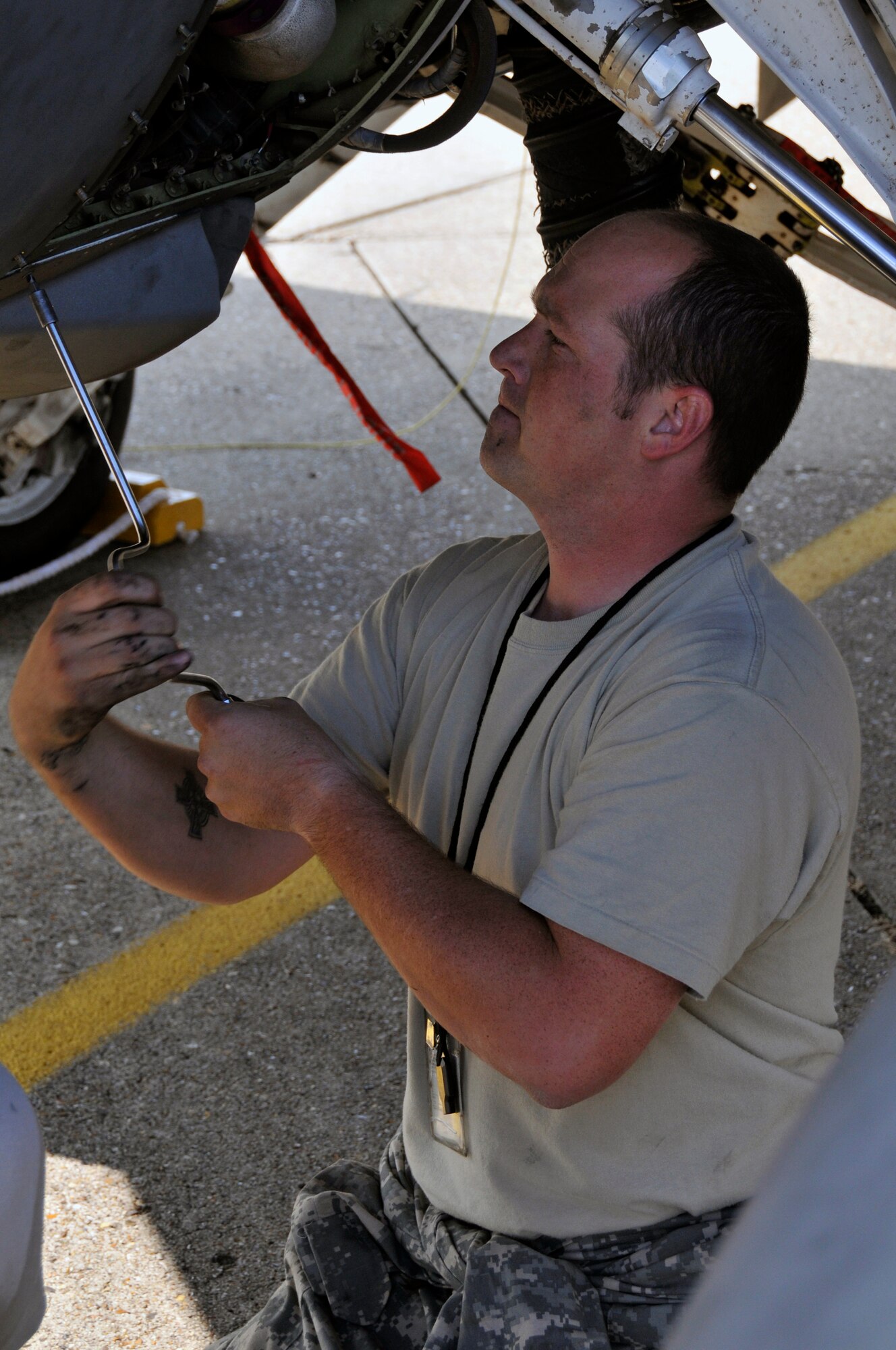 Staff Sgt. Jeremy Shores, 52nd Aircraft Maintence Squadron, replaces the panel underneath an F-16CJ from the 23rd Fighter Squadron July 24 at RAF Lakenheath, England. The crew chiefs, here from Spangdahlem, help keep the F-16's in top flying condition. (U.S. Air Force photo by Airman Perry Aston) 