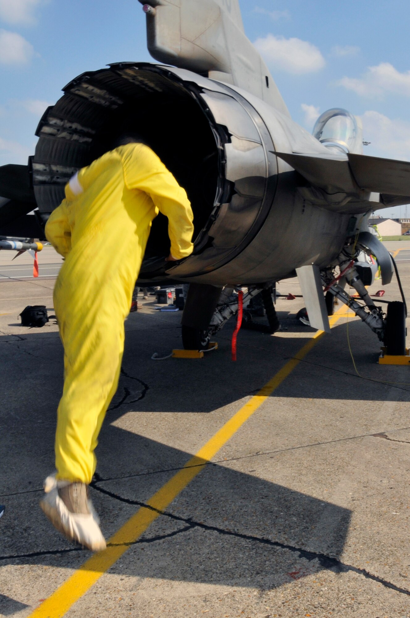 Senior Airman Jorge Villasenor, 52nd Aircraft Maintence Squadron crew chief jumps into the exhaust for inspection of an F-16CJ from the 23rd Fighter Squadron July 24 at RAF Lakenheath, England. The F-16 landed here because of mechanical problems it experienced during Operation Northern Fury.  (U.S. Air Force photo by Airman Perry Aston) 
