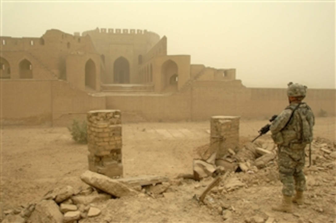 U.S. Army Spc. Nicholas Tripp, from Headquarters Troop, 3rd Squadron, 89th Cavalry Regiment, 4th Brigade Combat Team, 10th Mountain Division, looks at the remains of the Wistani Gate, one of the remaining four gates leading into the al-Rahseed district of Baghdad, Iraq, on July 27, 2008.  The soldiers are there to ensure the site has not been tampered with by vandals.  