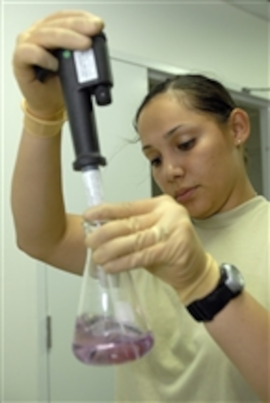 U.S. Air Force Tech. Sgt. Denisse Portunato, from the 332nd Expeditionary Aerospace Medicine Squadron, tests water from a base dining facility at Joint Base Balad, Iraq, on July 28, 2008.  Routine water checks ensure the baseís water meets required parameters and is safe for use.  
