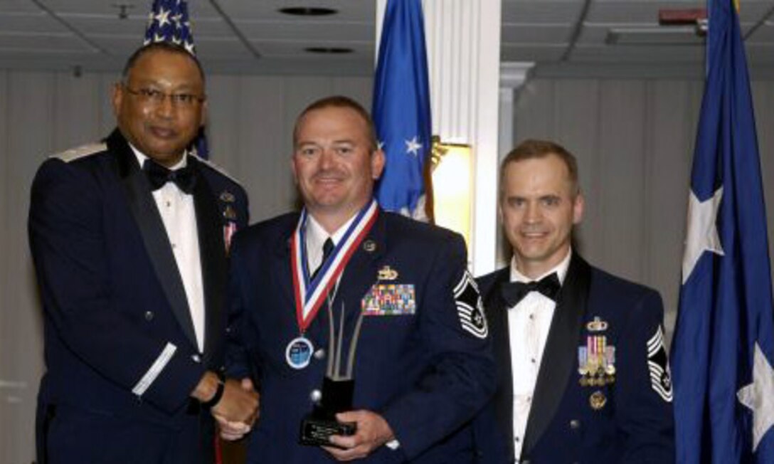 ARC Air Transportation Senior Non-Commissioned Officer of the year winner Senior MSgt. Dean E. Firestien, 39th Aerial Port Squadron, accepts his award for outstanding performance.  In addition, Lt. Col. James L. Gregory took high honors with the Major General Alice Astafan ARC Logistics Readiness Field Grade Officer of the year award.  Both members currently serve as Citizen Airmen for the 302nd Airlift Wing at Peterson Air Force Base, Colo. (U.S. Air Force Courtesy Photo.)