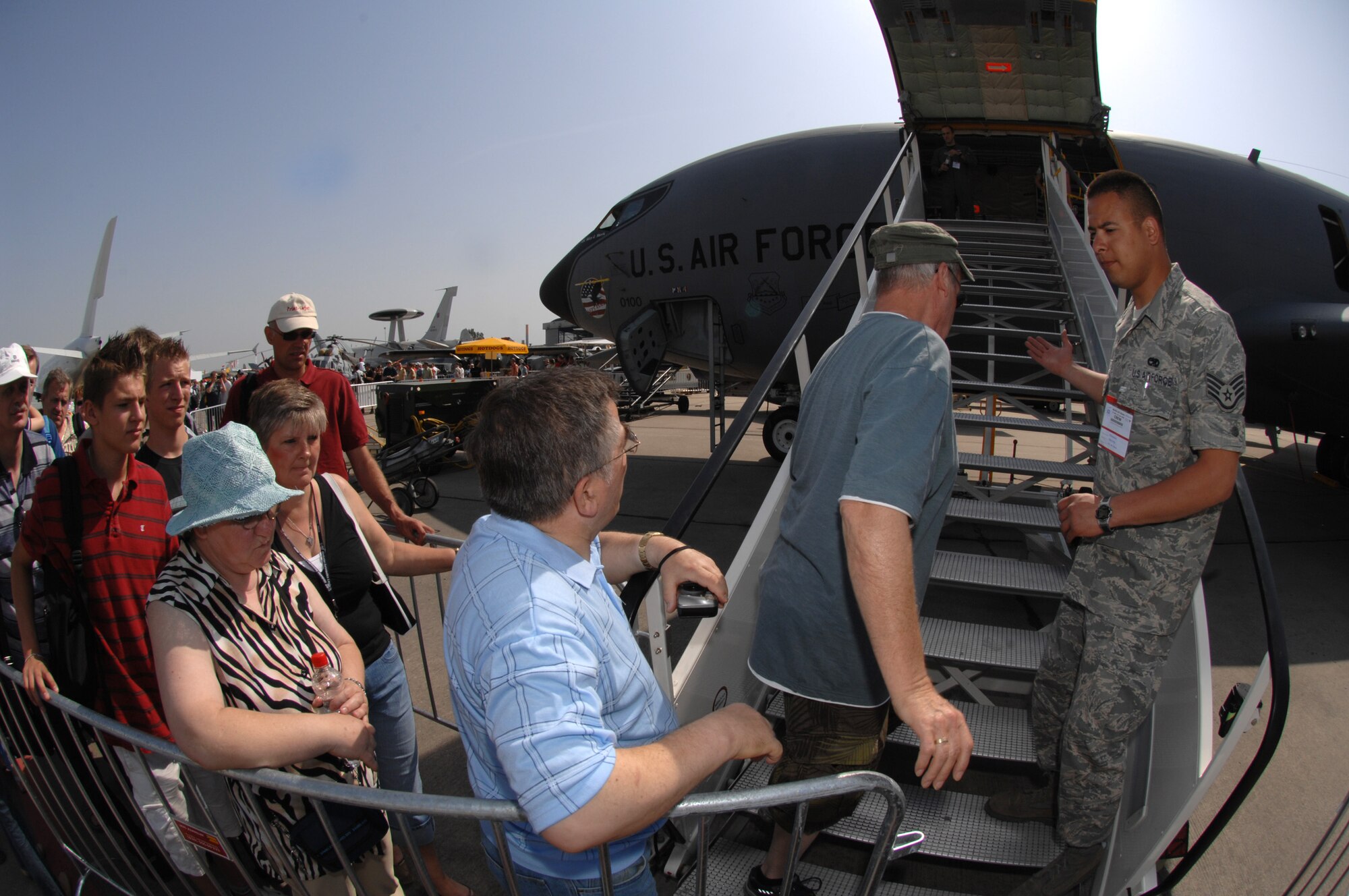 BERLIN, Germany - Staff Sgt. Brandon Sroufe from the 100th Aircraft Maintenance Squadron at Royal Air Force Mildenhall escorts air show guests onto the KC-135R during the 2008 Berlin Air Show, May 31.  U.S. participation in the Berlin Air Show enhances the U.S.-German military-to-military relationship, supports our security cooperation strategic direction efforts, and fosters good relations and better understanding among nations. (U.S. Air Force photo by Tech. Sgt. Corey Clements) (released)