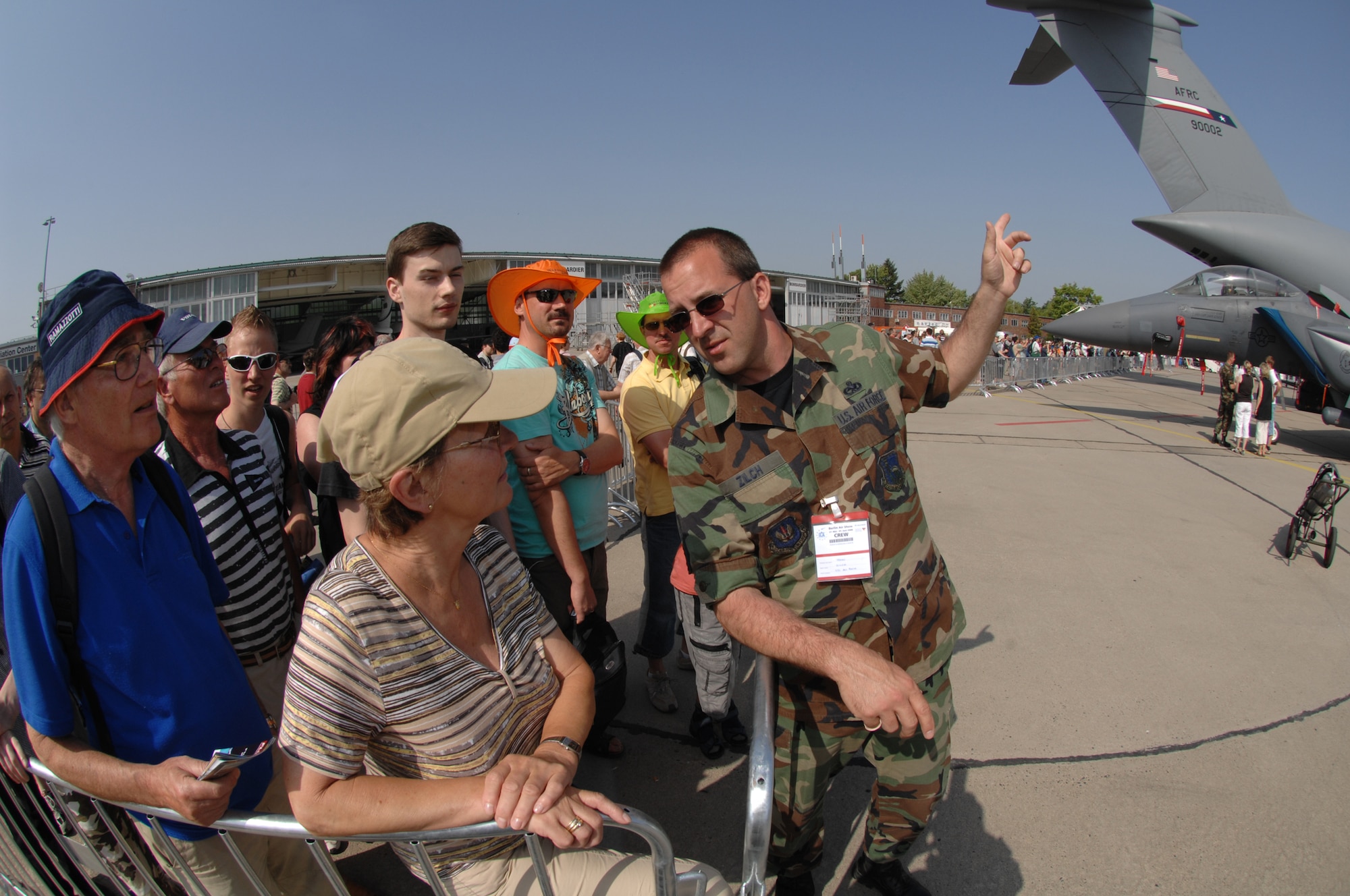 BERLIN, Germany - Master Sgt. John Zilch from the 493rd Aircraft Maintenance Unit at Royal Air Force Lakenheath answers questions from air show guests while they wait to tour the U.S. corral during the 2008 Berlin Air Show.  U.S. participation in the Berlin Air Show enhances the U.S.-German military-to-military relationship, supports our security cooperation strategic direction efforts, and fosters good relations and better understanding among nations. (U.S. Air Force photo by Tech. Sgt. Corey Clements) (released)