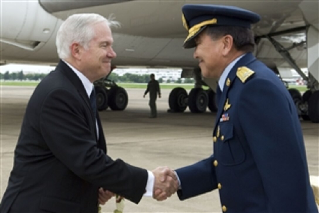 Upon his arrival in Bangkok, Thailand, U.S. Defense Secretary Robert M. Gates, left, shakes hands with Air Chief Marshal Chalit Pookpasuk of the Royal Thai Air Force, June 1, 2008.  