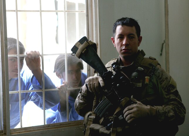 Petty Officer 2nd Class Mark Dotson, a corpsman with Task Force 2nd Battalion, 2nd Marines, Regimental Combat Team 5, attends a graduation ceremony at the Vocational Training Center in Husaybah, Iraq, June 1. The school graduated 244 students during their third cycle, compared to an average of 162 from two previous classes.