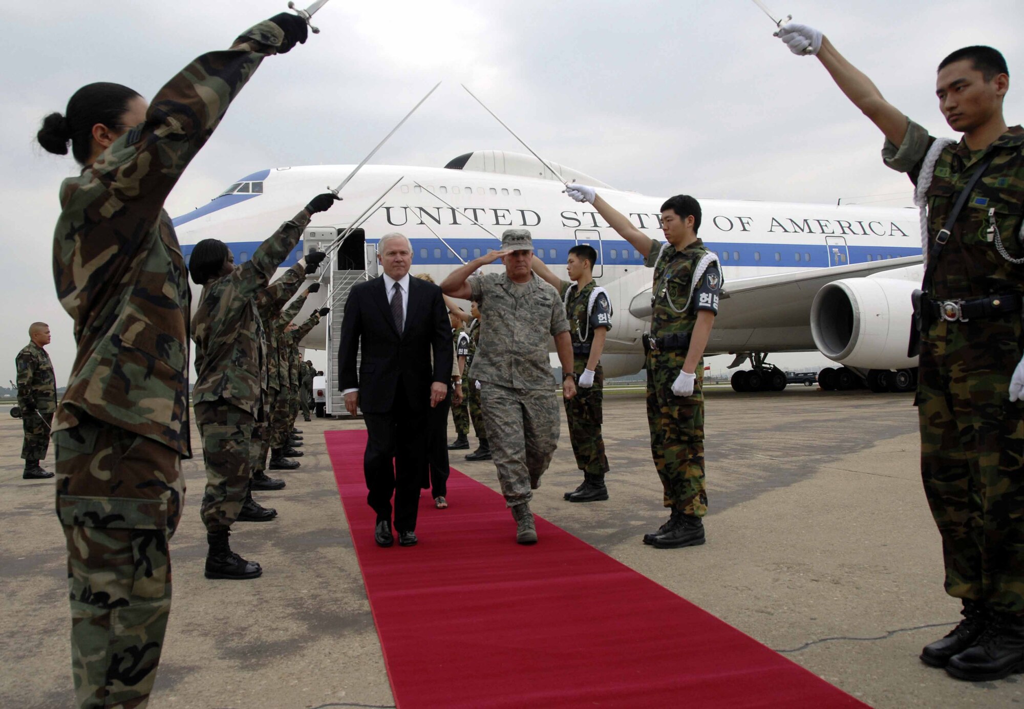 OSAN AIR BASE, Republic of Korea -- Secretary of Defense Robert Gates walks through an honor cordon with Lt. General Stephen Wood, 7th AF commander, after arriving here June 2. (U.S. Air Force photo/Senior Airman Christopher Boitz) 