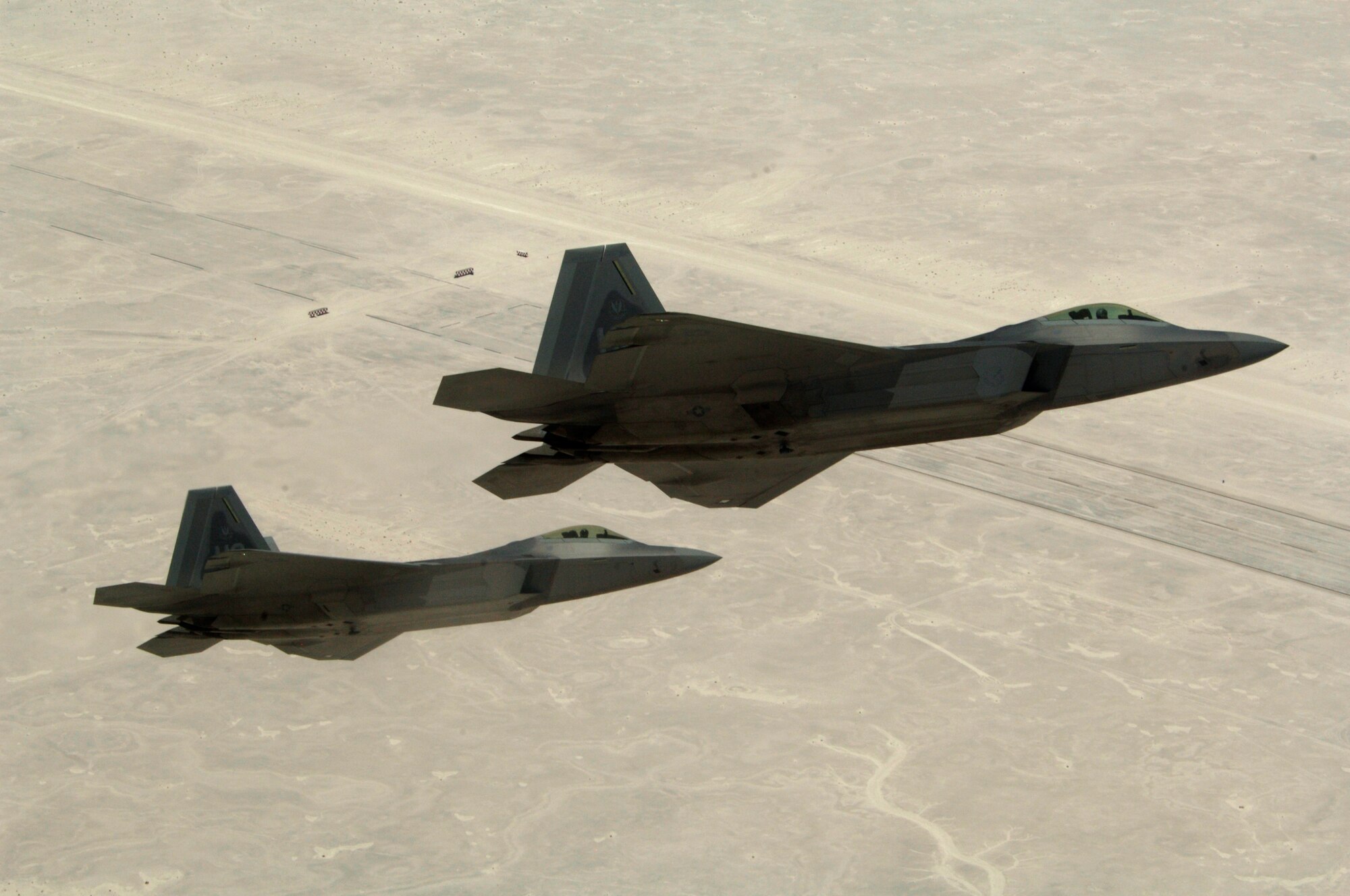 Col. Jeff Harrigian, 49th Fighter Wing commander, and Lt. Col. Mike Hernandez, 7th Fighter Squadron commander, fly a pair of F-22A Raptors over White Sands Missile Range, on the way to Holloman Air Force Base, N.M., June 2. The jets are the first two Holloman-tailed F-22's to arrive on base. (U.S. Air Force Photo/ Senior Airman Russell Scalf)