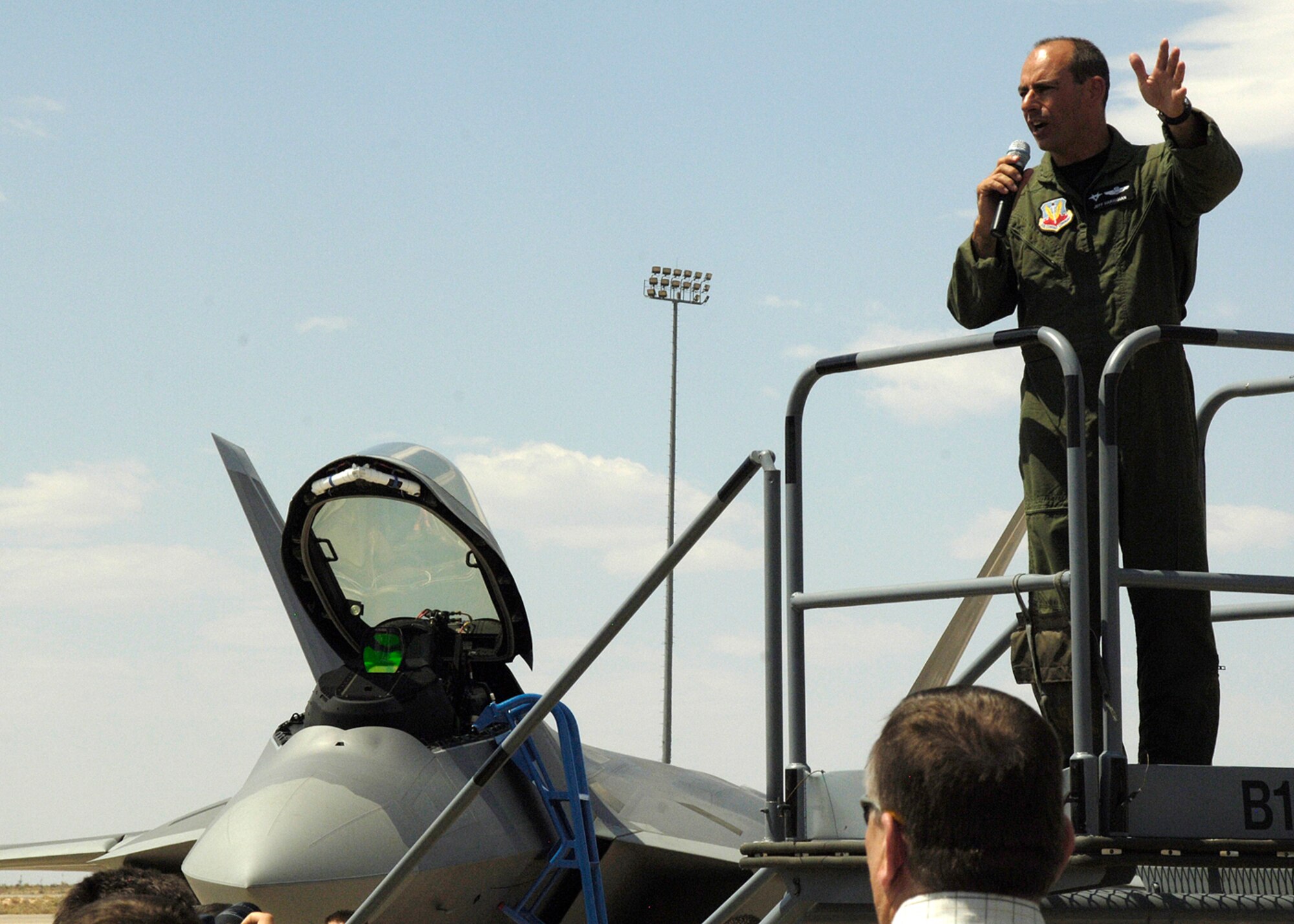 Col. Jeff ?Cobra? Harrigian, 49th Fighter Wing commander, speaks briefly after flying in one of the first two F-22A Raptors to Holloman Air Force Base, N.M., at Hangar 301, June 2. The colonel thanked everyone for coming out and asked that the crowd give themselves round of applause for all the hard work they?ve done in preparation for the day. (U.S. Air Force photo/Airman 1st Class Michael Means)