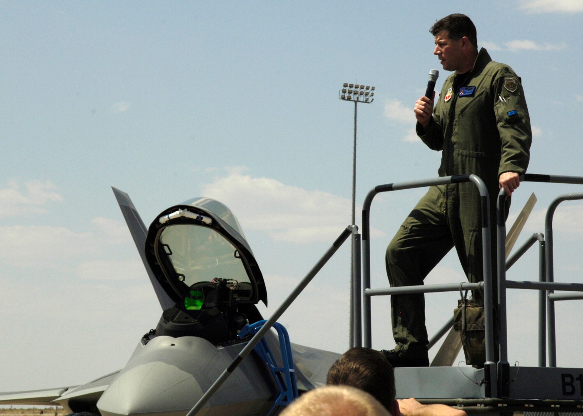 Lt. Col. Mike ?PigPen? Hernandez, 7th Fighter Squadron commander, speaks to the crowd after the arrival of Holloman?s first two F-22A Raptors. Colonel Hernandez and Col. Jeff ?Cobra? Harrigian, 49th Fighter Wing commander, land the F-22?s near Hangar 301 at Holloman Air Force Base, N.M., June 2. (U.S. Air Force photo/Airman 1st Class Michael Means)