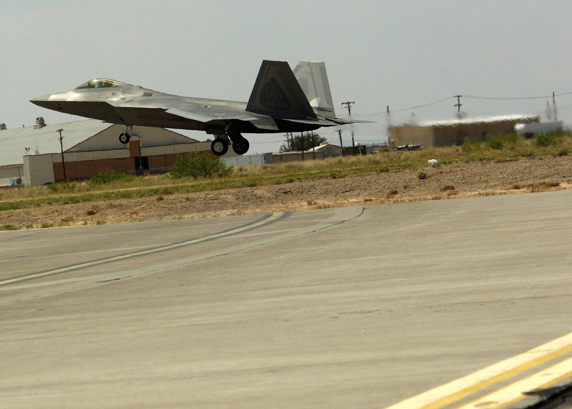 One of two F-22A Raptors land at Holloman Air Force Base, N.M., June 2. The jets flew over the Tularosa Basin prior to landing at Holloman giving the community a chance to witness the future of Holloman. (U.S. Air Force photo/Airman 1st Class Michael Means)