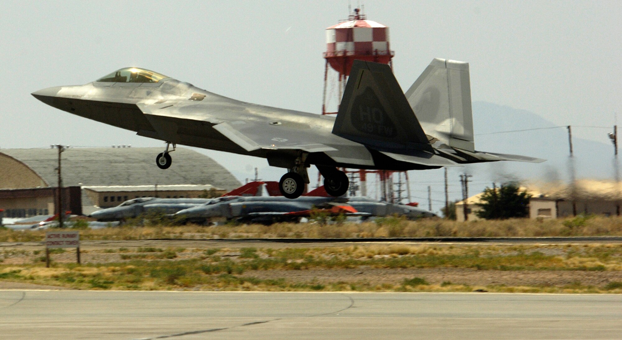 One of two F-22A Raptors lands at Holloman Air Force Base, N.M., June 2. The jets are the first two Holloman-tailed F-22s to arrive on base. Prior to landing, the jets flew over the Tularosa Basin, allowing the local community a chance to witness the future of Holloman. (U.S. Air Force photo/Airman 1st Class Michael Means)