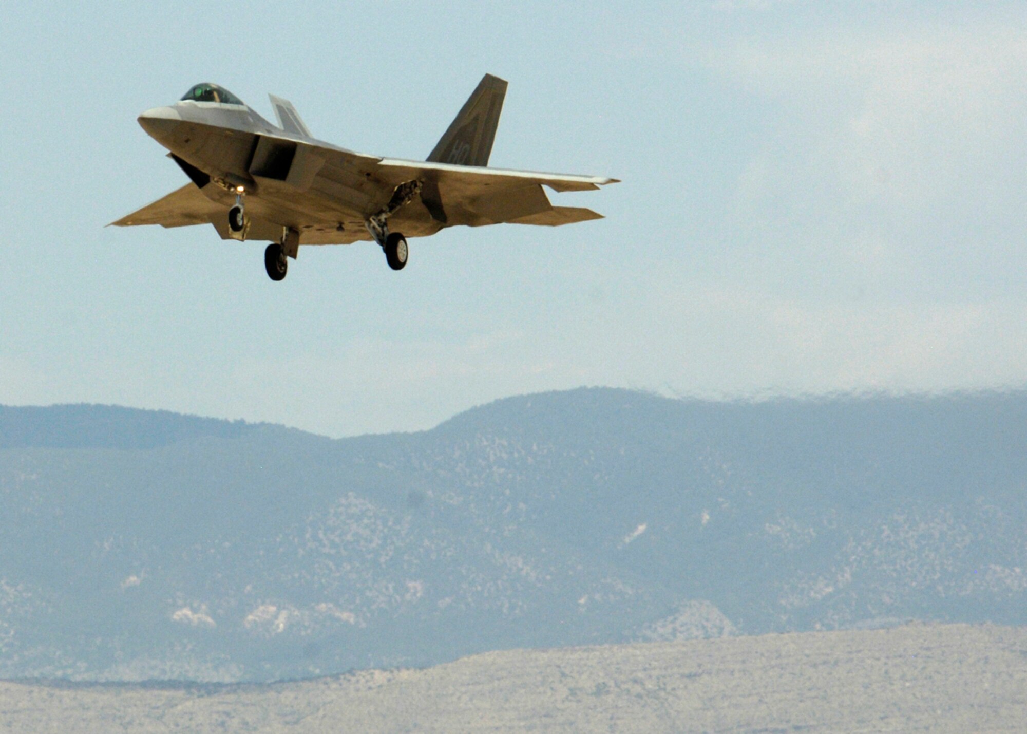 One of two F-22A Raptors prepares to land at Holloman Air Force Base, N.M., June 2. The jets are the first two Holloman-tailed F-22s to arrive on base. Prior to landing, the jets flew over the Tularosa Basin, allowing the local community a chance to witness the future of Holloman. (U.S. Air Force photo/Airman 1st Class Michael Means)