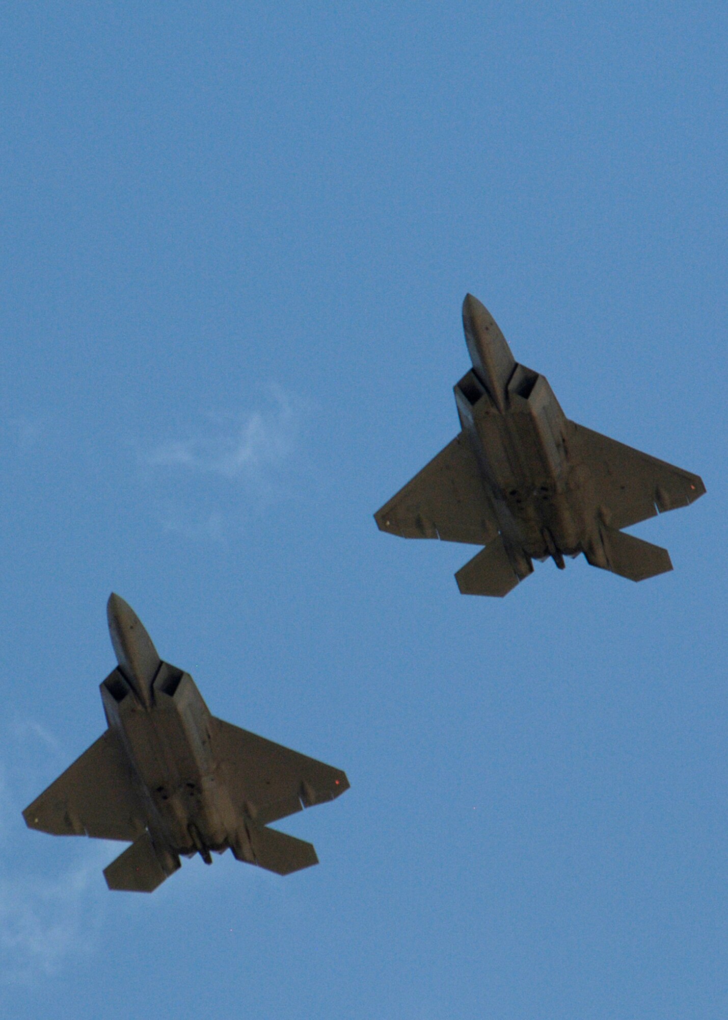 Col. Jeff Harrigian, 49th Fighter Wing commander, and Lt. Col. Mike Hernandez, 7th Fighter Squadron commander, fly a pair of F-22A Raptors over the skies of Holloman Air Force Base, N.M., June 2. The jets are the first two Holloman-tailed F-22s to arrive on base. Prior to landing, the jets flew over the Tularosa Basin, the community had the chance to witness the future of Holloman. (U.S. Air Force photo/Airman 1st Class Michael Means)