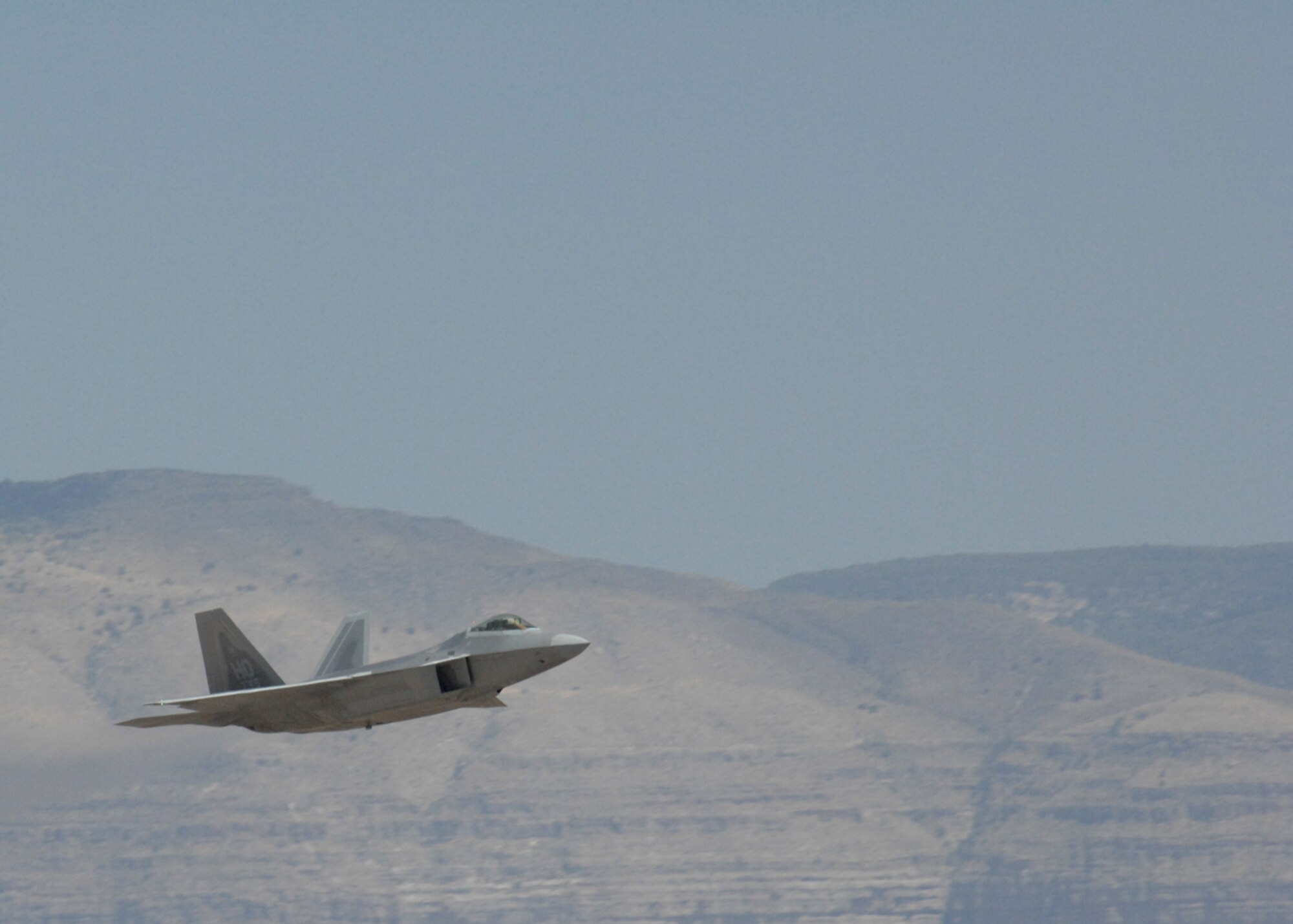 One of two F-22A Raptors fly over Holloman Air Force Base, N.M., June 2. The jets are the first two Holloman-tailed F-22s to arrive on base. Prior to landing, the jets flew over the Tularosa Basin, allowing the local community a chance to witness the future of Holloman. (U.S. Air Force photo/Senior Airman Tiffany Trojca)