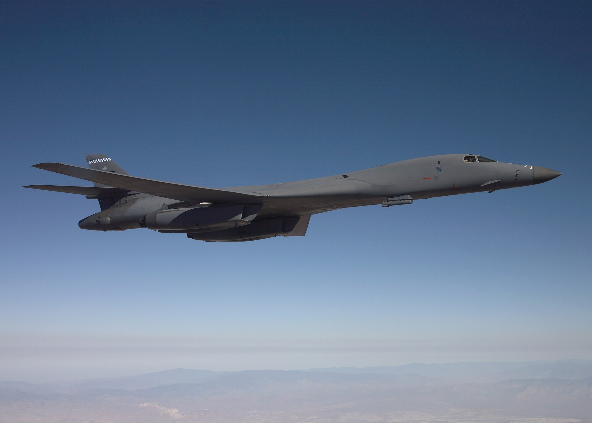 A B-1B Lancer flies on a testing mission carrying a sniper pod. The sniper pod is scheduled to be fully operational by summer. (Air Force photo by Jet Fabara)