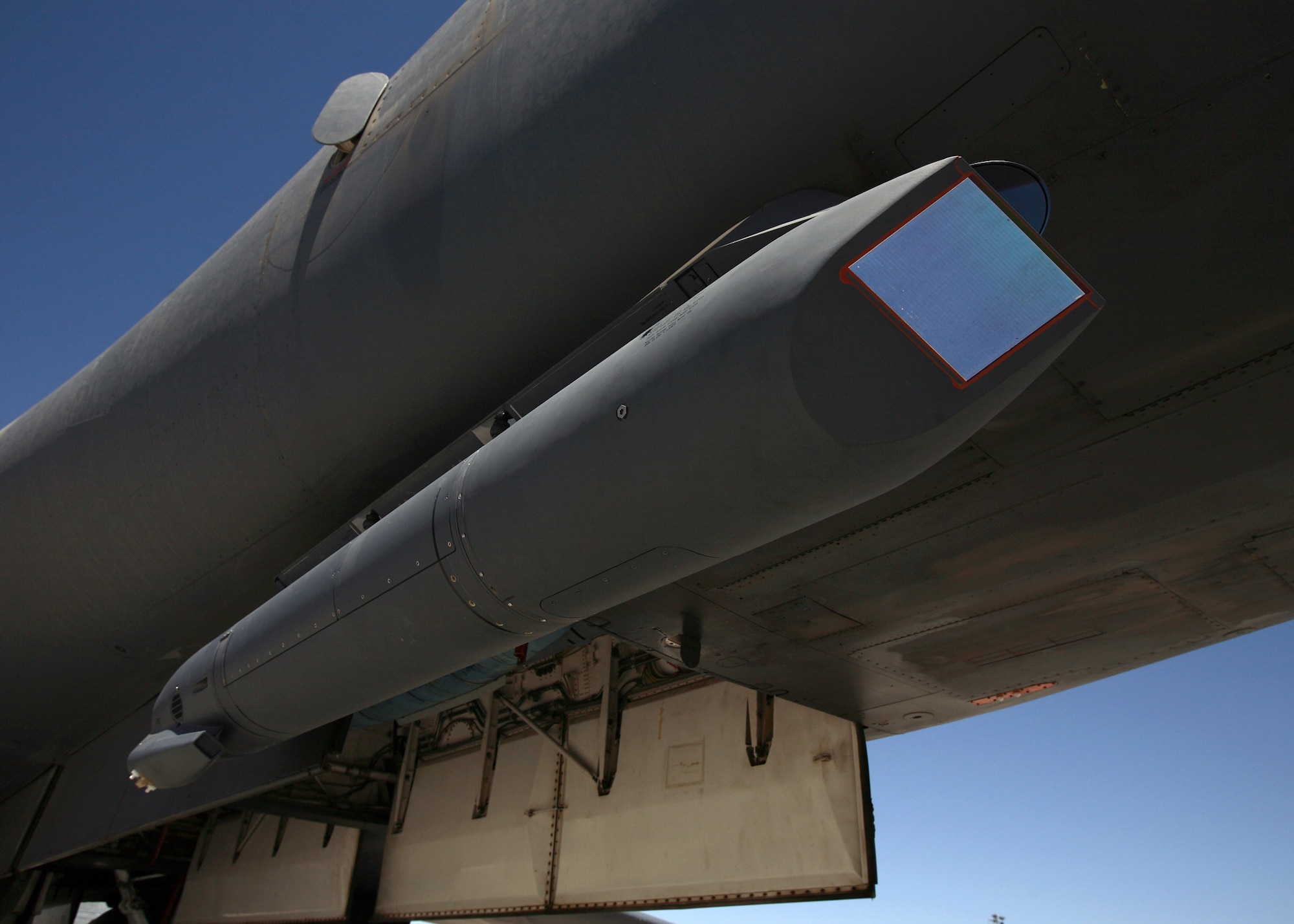 A sniper pod is mounted on the lower right of a B-1B Lancer fuselage. The sniper pod allows the aircrew to positively identify a target and quickly assess battle damage after an attack. (Air Force photo by Jet Fabara)