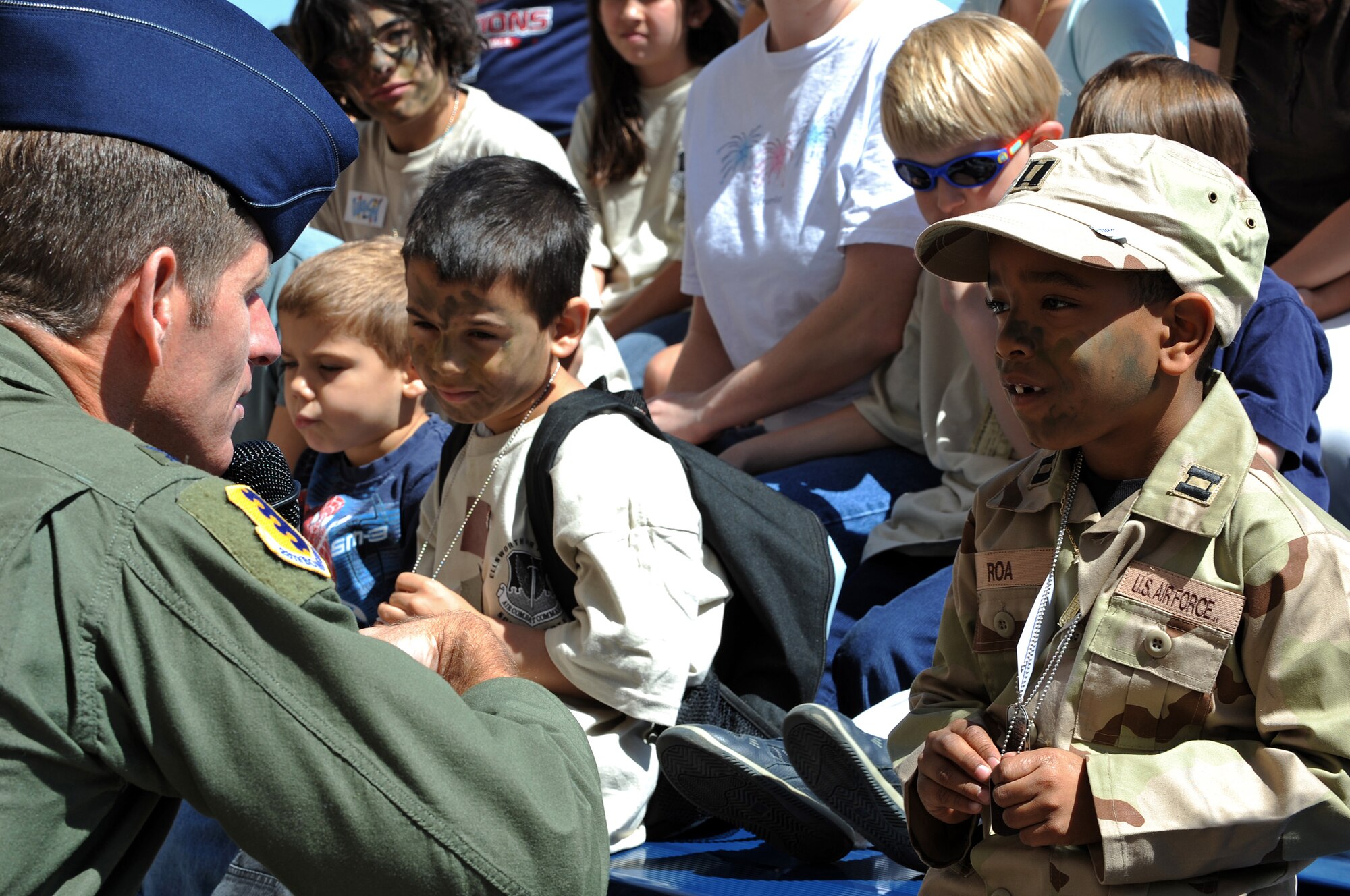 Javiel Roa, son of Tech. Sgt. Karian Roa, 28th Logistics Readiness Squadron unit deployment manager, talks to Col. Peter Caster, 28th Bomb Wing vice commander, during Operation Awareness 2008 here, May 31.  The operation gave children the chance to see how their parents get ready for deployment. (U.S. Air Force photo/Senior Airman Marc I. Lane)
