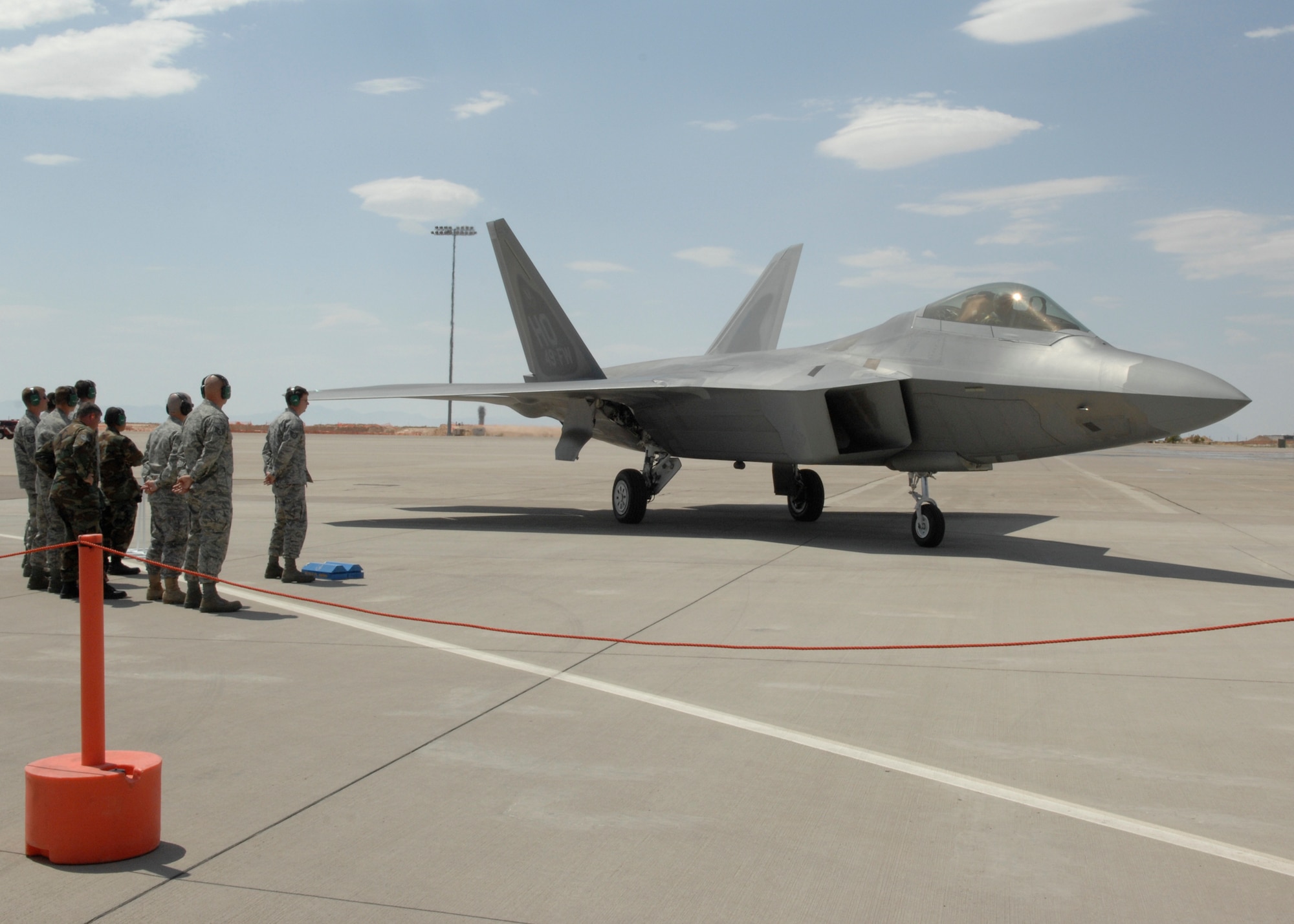 Flight line personnel wait for an F-22 to perform shutdown checks on Holloman Air Force Base, N.M., June 2.This is one of the first F-22s assigned to Holloman. (U.S. Air Force photo/Airman 1st Class Rachel A. Kocin)