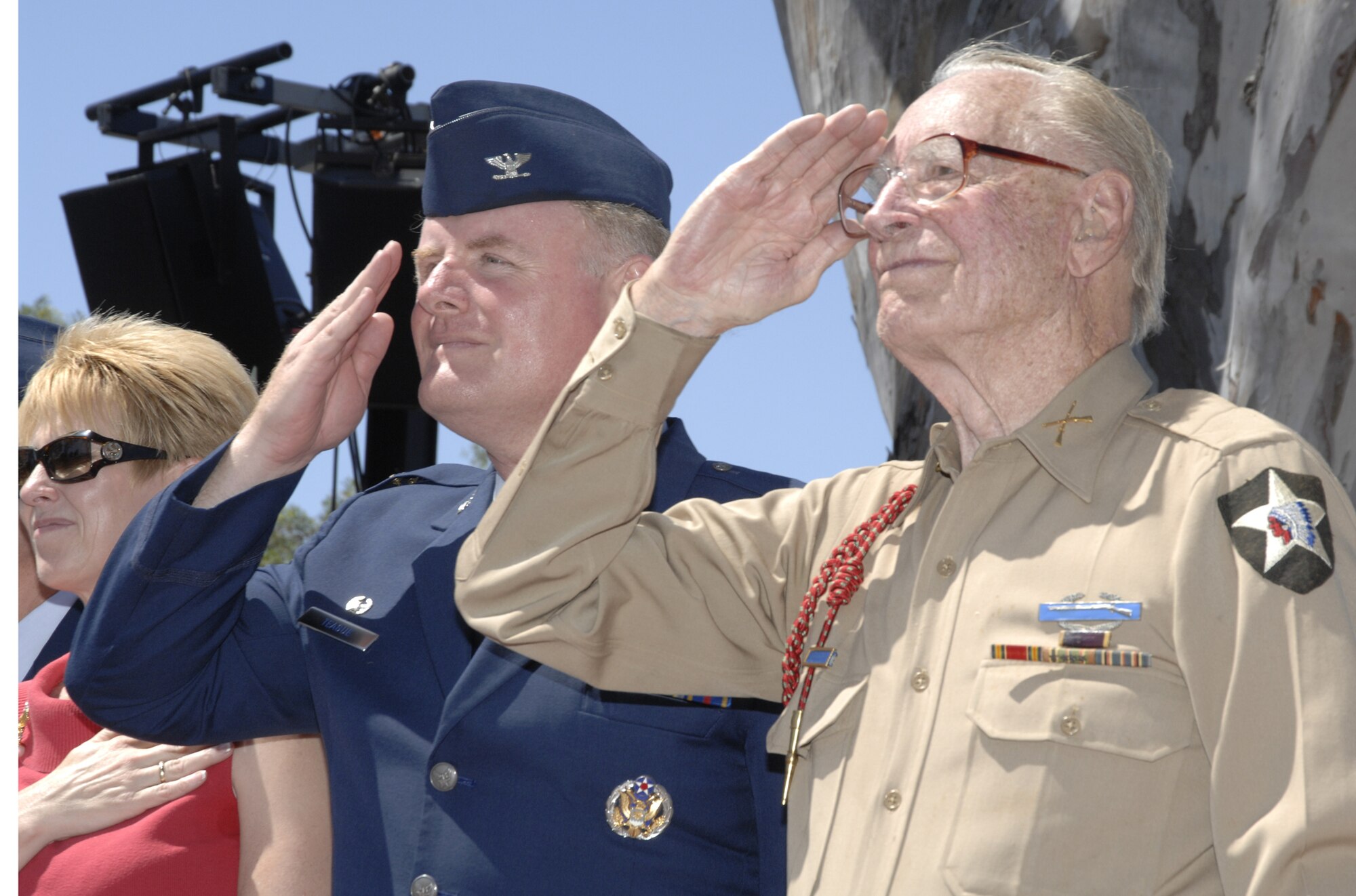 Colonel Roger W. Teague, SBIRS Wing commander, and an unidentified retiree salute passing parade participants during this year’s Torrance Armed Forces Day parade, May 17.  (Photo by Joe Juarez)