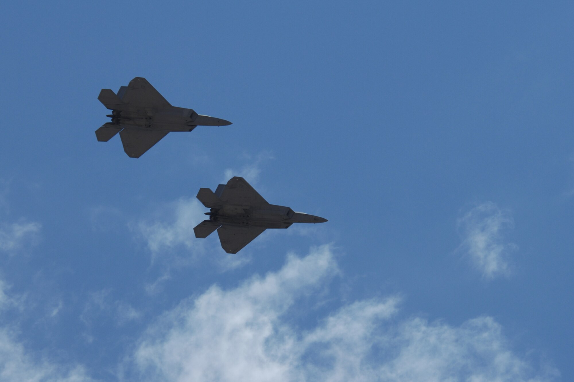 Col. Jeff Harrigian, 49th Fighter Wing commander, and Lt. Col. Mike Hernandez, 7th Fighter Squadron commander, fly a pair of F-22A Raptors over the skies of Holloman Air Force Base, N.M., June 2. Flying from Nellis Air Force Base, Nev., Colonel Harrigian's call sign was Sun 11 and Colonel Hernandez's call sign was Sun 12. The jets are the first two F-22s assigned to Holloman. (U.S. Air Force photo/Airman 1st Class Jamal D. Sutter)