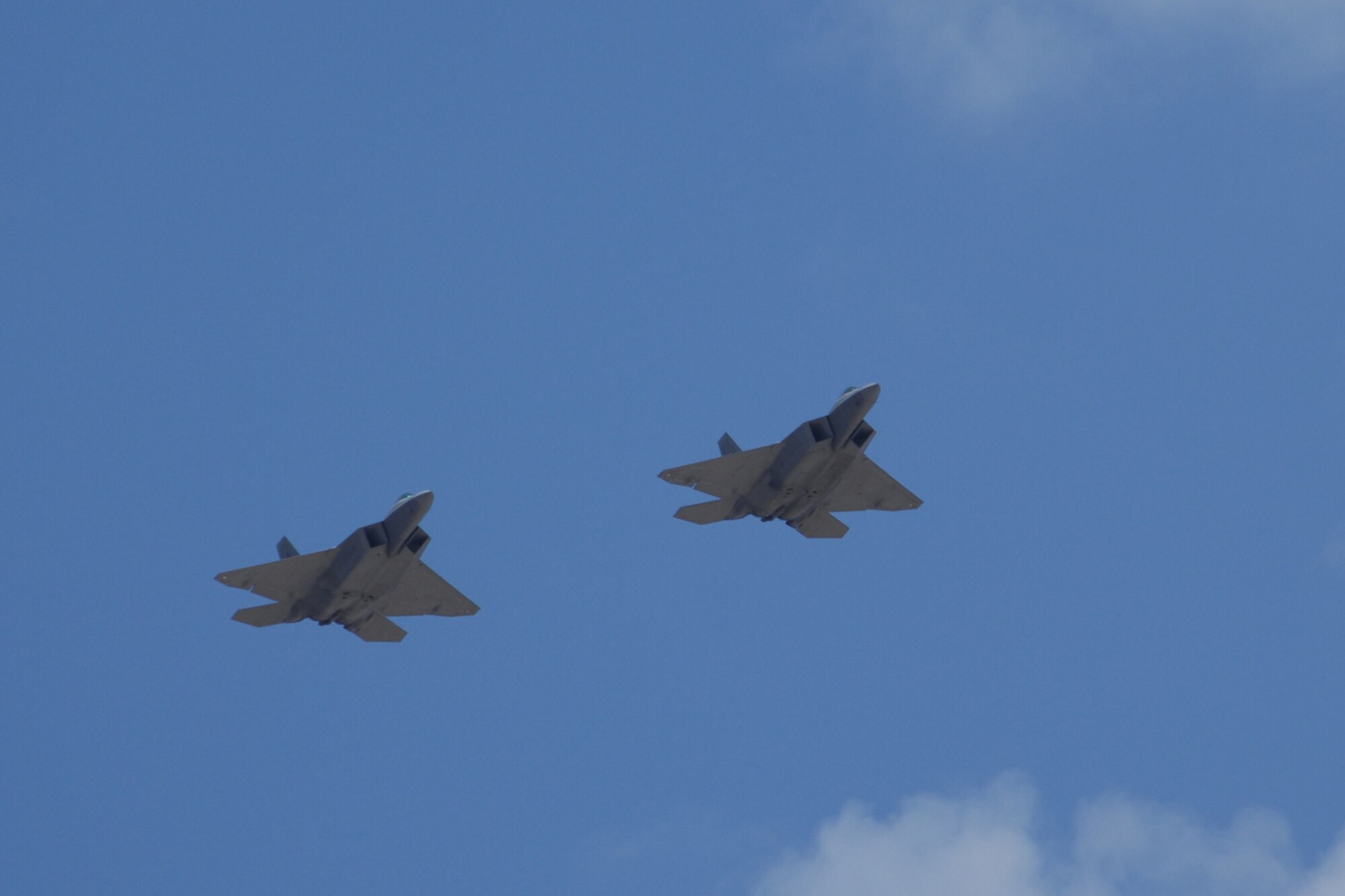 Col. Jeff Harrigian, 49th Fighter Wing commander, and Lt. Col. Mike Hernandez, 7th Fighter Squadron commander, fly a pair of F-22A Raptors over the skies of Holloman Air Force Base, N.M., June 2. The jets are the first two Holloman-tailed F-22s to arrive on base. Prior to landing, the jets flew over the Tularosa Basin, allowing the local community a chance to witness the future of Holloman Air Force Base. (U.S. Air Force photo/Airman 1st Class Jamal D. Sutter)