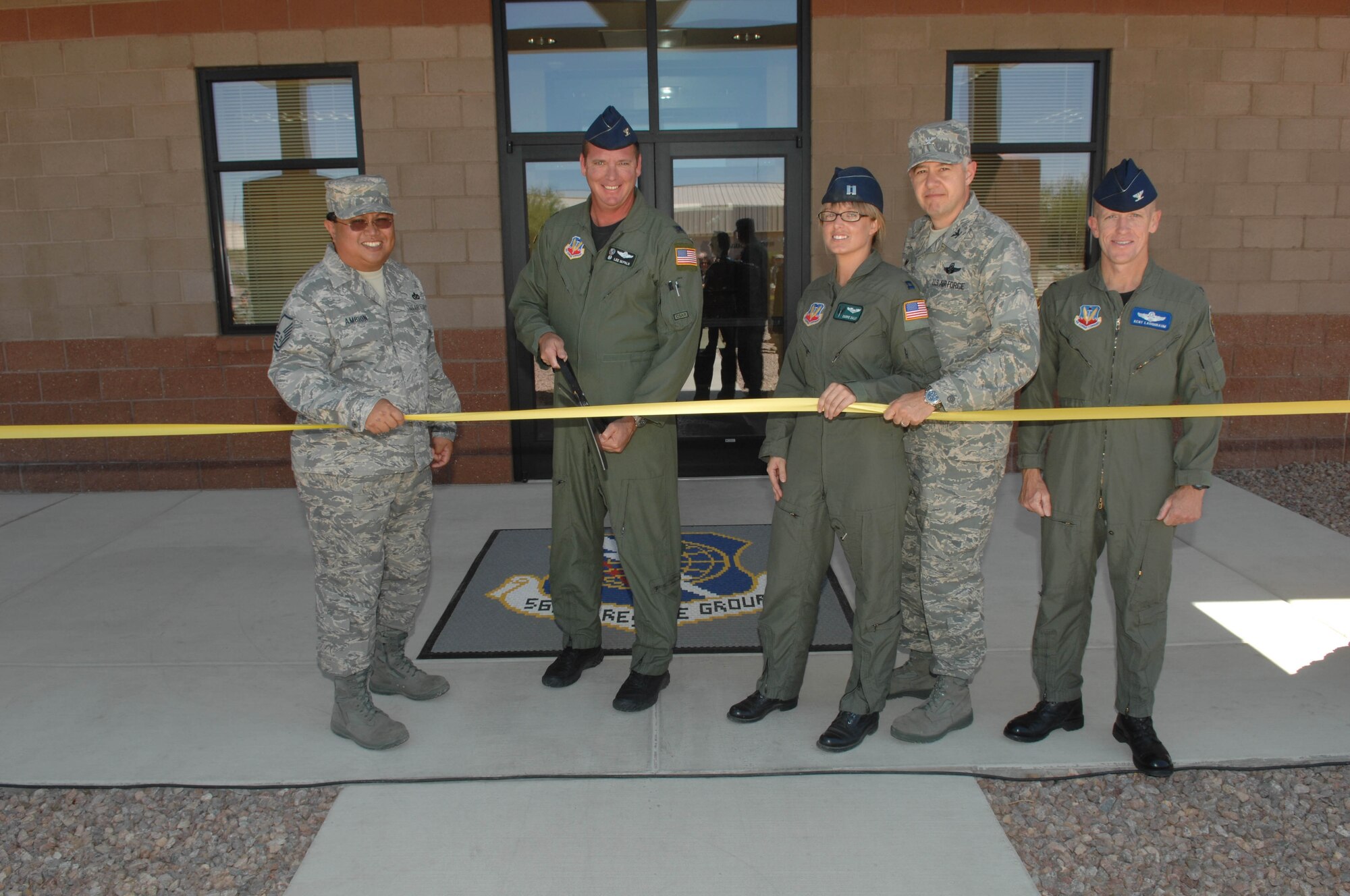 Master Sgt. Joel Ambion, 355th Civil Engineer Squadron, Col.  Lee DePalo, 563rd Rescue Group commander, Capt. Carrie Dally, 563rd Operations Support Squadron,  Col. Kenneth Todorov, 23rd Wing commander, and Col. Kent Laughbaum 355th Fighter Wing commander, cut the ribbon for the new 563rd Group building here on May 30, 2008.  This new building will be used by the 563rd Maintenance Squadron, 563rd Operations Support Squadron, 48th Rescue Squadron, 55th Rescue Squadron, and the 79th Rescue Squadron.  The mission of these different squadrons is to be successful in flying operations and ensuring the combat search and rescue can be successful in saving lives.  (US Air Force Photo By: Senior Airman Jacqueline Hawkins)