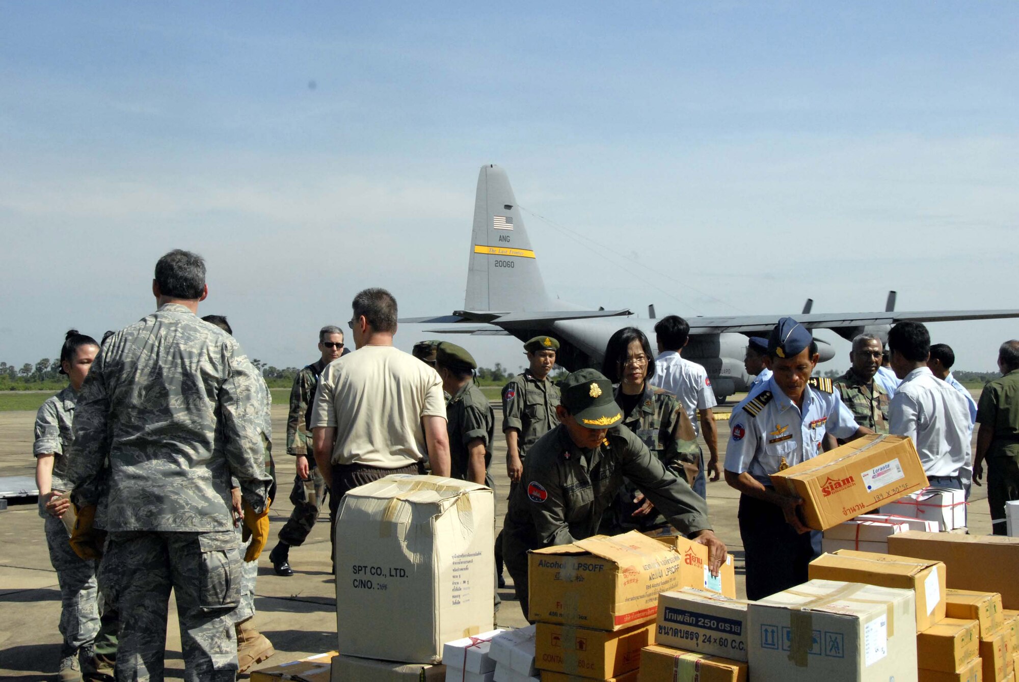 American servicemembers and Royal Cambodian armed forces members move supplies May 24 at Chhnang Province, Cambodia. Multinational medical teams distributed the supplies to forward-operating locations for Operation Pacific Angel. The operation is a joint/combined humanitarian assistance operation in support of capacity-building efforts. Participating services include the active duty, Reserve and National Guard components of the Air Force, Army, Royal Thai air force, and Royal Cambodian armed forces. (U.S. Air Force photo/Tech. Sgt. Tom Czerwinski) 
