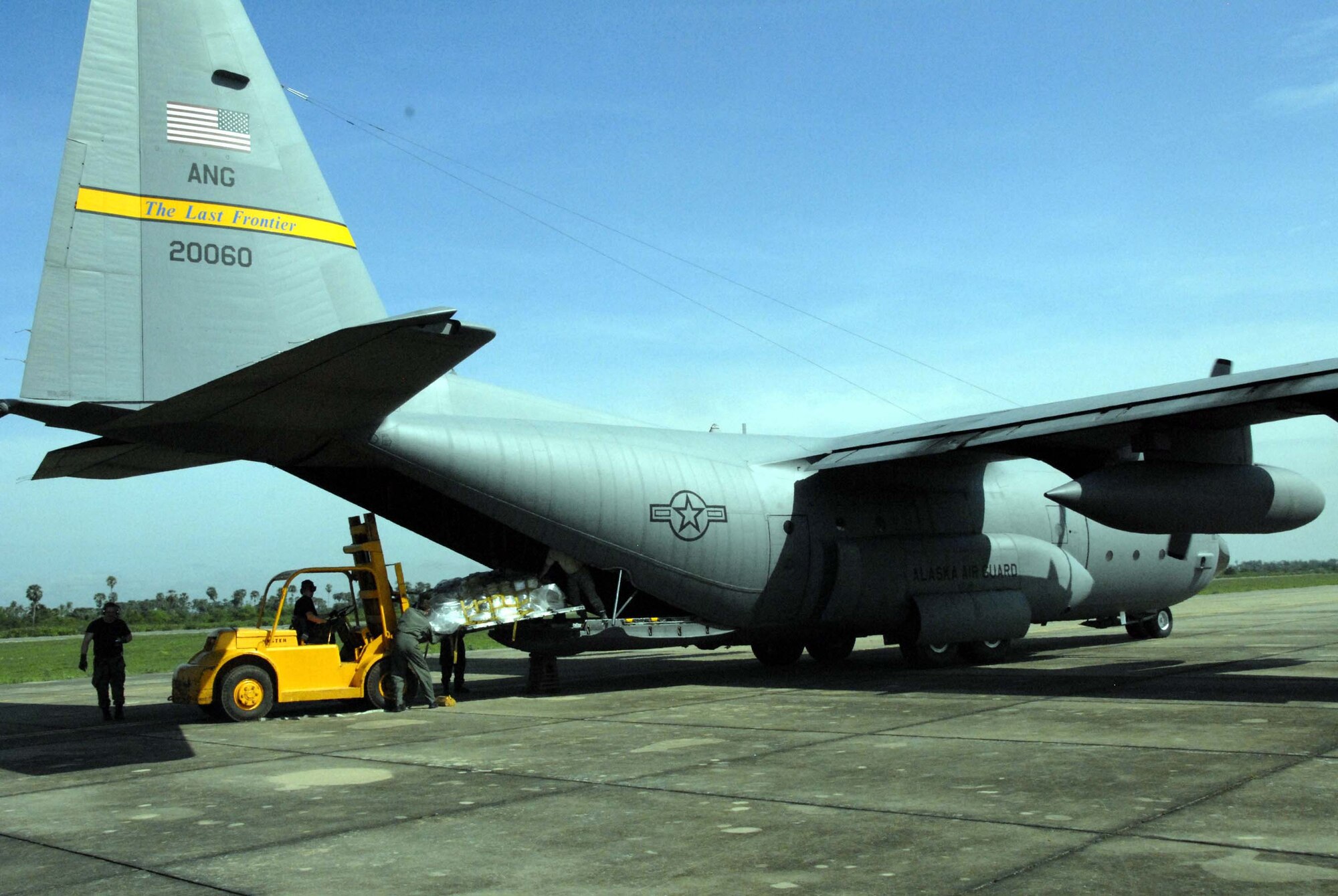 A forklift offloads 3,000 pounds of medical supplies from a C-130 Hercules May 24 after landing at Kampong Chhnang Province Airfield, Cambodia. An awaiting multinational team of medical professionals broke down the supplies and moved them to clinics in Kampong Chhnang and Kampong Cham provinces in support of Operation Pacific Angel, a joint/combined humanitarian assistance operation in support of capacity-building efforts. Participating services include the active duty, Reserve and National Guard components of the Air Force, Army, Royal Thai air force, and Royal Cambodian armed forces. The C-130 is from the 144th Airlift Squadron from Kulis Air National Guard Base, Alaska. (U.S. Air Force photo/Tech. Sgt. Tom Czerwinski)
