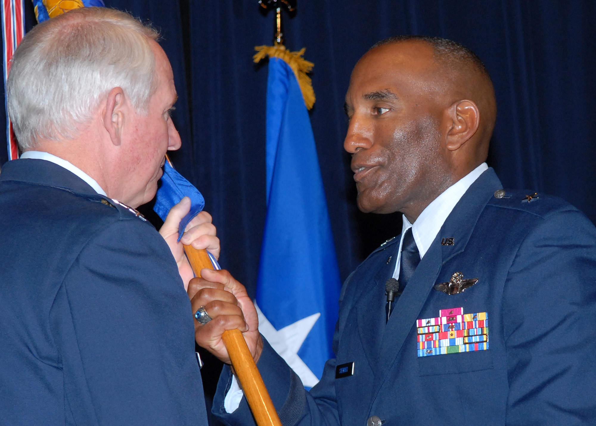 Brig. Gen. Alfred J. Stewart, right, accepts the Air Force Recruiting Service guidon and AFRS command from Gen. William R. Looney III, Air Education and Training Command commander, during a change of command ceremony June 2 on Randolph Air Force Base, Texas. As AFRS commander, General Stewart is responsible for accessing qualified men and women to meet the personnel procurement requirements of the Air Force. (U.S. Air Force photo/Rich McFadden)
