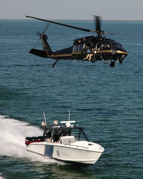 Agents from the U.S. Customs and Border Protection (CBP) Miami Air and Marine Branch, located at Homestead Air Reserve Base, operate a Black Hawk helicopter and Midnight Express interceptor class vessel. The same types of helo and boat were used when CBP Air and Marine agents based at Homestead ARB assisted in the interdiction of 35 migrants and one suspected smuggler off the coast of Palm Beach, Fla., on May 23. (Courtesy photo by Zach Mann, CPB public information officer)

