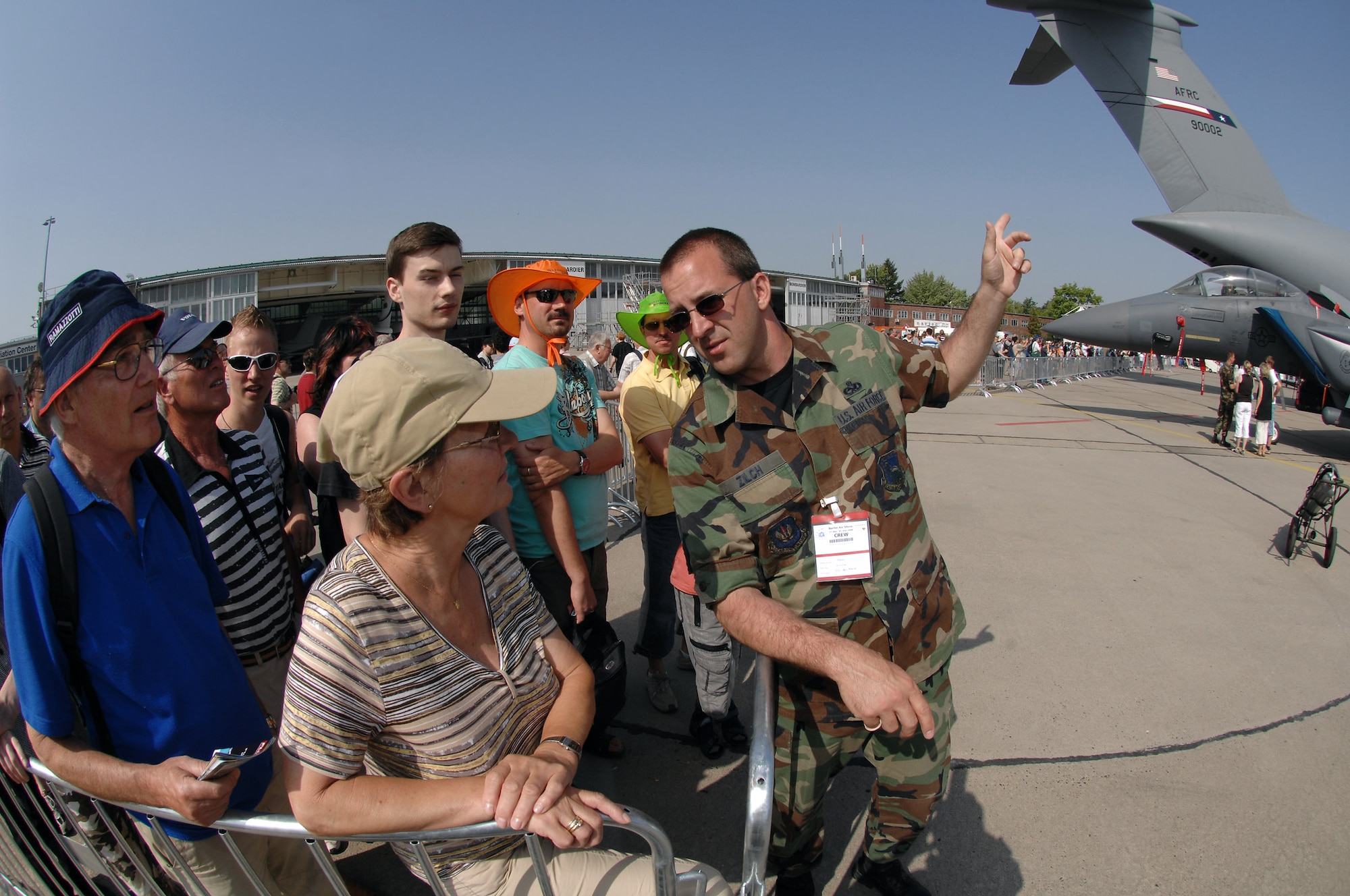 Master Sgt. John Zilch answers questions from airshow guests while they wait to tour the U.S. corral during the 2008 Berlin Airshow. U.S. participation in the Berlin Airshow enhances the U.S.-German military-to-military relationship, supports security cooperation strategic direction efforts and fosters good relations and better understanding among nations. Sergeant Zilch is from the 493rd Aircraft Maintenance Unit at Royal Air Force Lakenheath, U.K. (U.S. Air Force photo/Tech. Sgt. Corey Clements) 