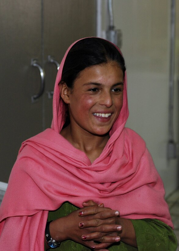 Lamia, a 10-year-old Afghan girl from Shakal Village in Afghanistan, shows her appreciation to the donated items sent from Jan Bradley, wife of Lt. Gen. John Bradley, Air Force Reserve Command commander. Mrs. Bradley spearheaded a donation drive that provided several boxes of housewares, clothing, shoes, toys and toiletries that were presented here May 30. (U.S. Air Force photo/Capt. Toni Tones) 