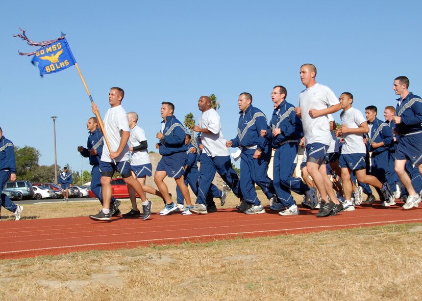 Members of the 60th Logistics Readiness Squadron cross the finish line of a "Fun Run".  Hundreds of Airman from Travis Air Force Base, California participated in the 2.5 mile run.  The run kicked off the "101 Critical Days of Summer" promoting safety awareness and encouraging common sense when the Airman partake in summer activities.  USAF photo by Civ/Nan Wylie