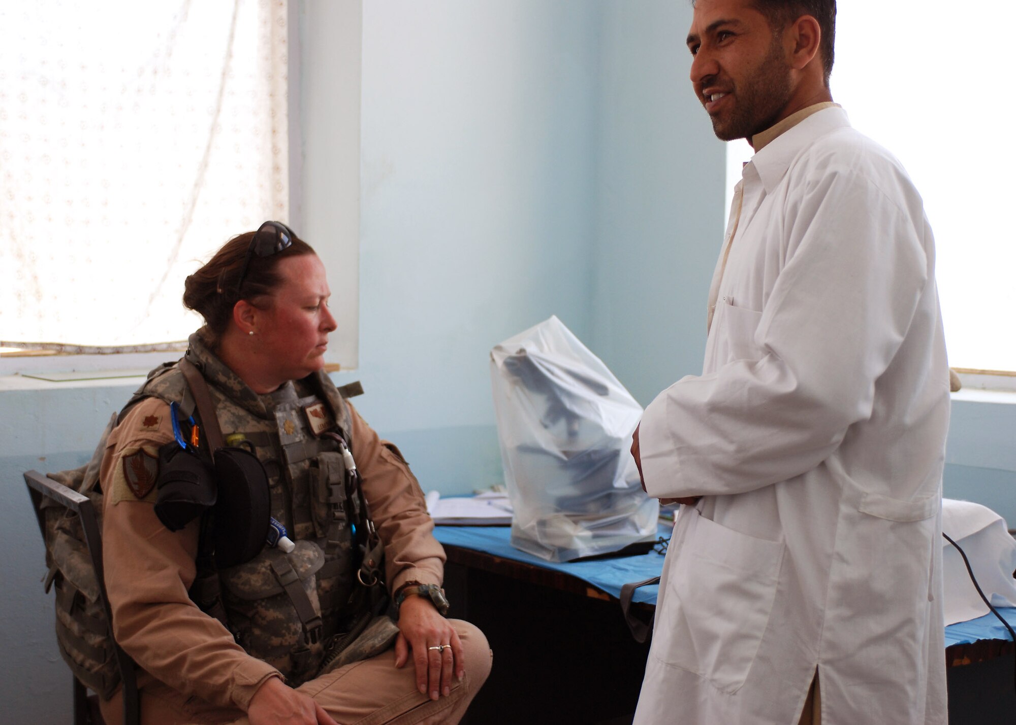 Maj. Lena Soto, while inspecting medical equipment at the Jegdalak Medical Health Center in Jegdalak, Afghanistan, discusses issues with a medical technician. Major Soto and her team from Combined Security Transition Command-Afghanistan Command Surgeon's office regularly inspect clinics like the Jegdalak Medical Health Center to guarantee the services meet the needs of the Afghan people. (U.S. Air Force photo/Navy Petty Officer 1st Class Douglas Mappin)