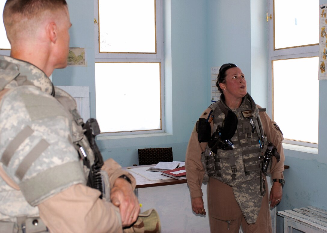 Lt. Col. Devin Donnelly (left) and Maj. Lena Soto inspect a treatment room at the Jegdalak Medical Health Centerin Jegdalak, Afghanistan. The inspection team from Combined Security Transition Command-Afghanistan Command Surgeon's office regularly inspect clinics like the Jegdalak Medical Health Center to guarantee their services meet the needs of the Afghan people. (U.S. Air Force photo/Navy Petty Officer 1st Class Douglas Mappin)